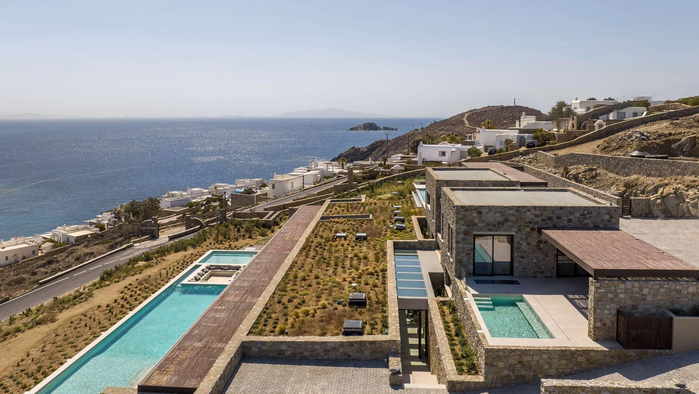 photo of house near cliff and body of water