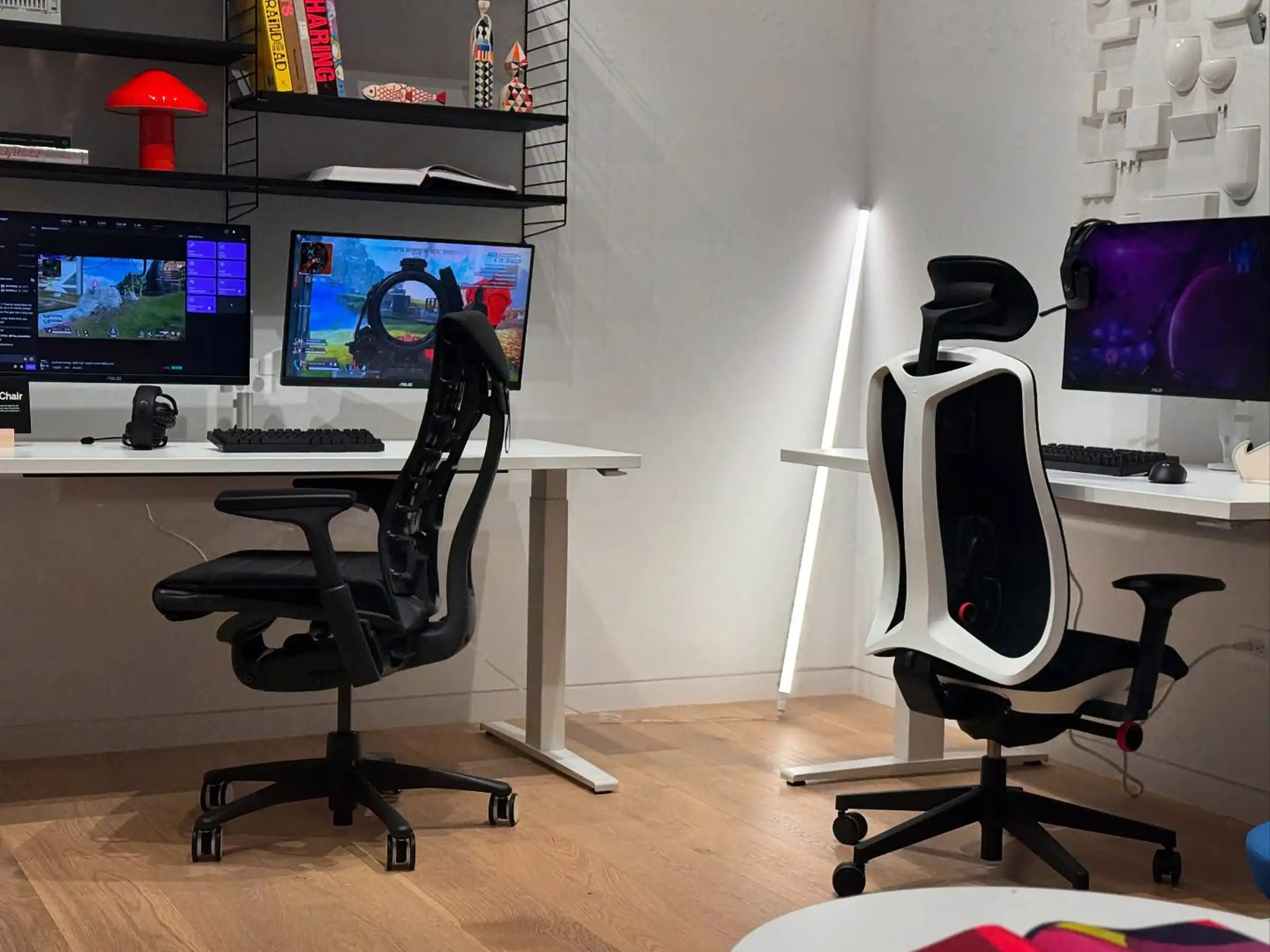 Light hardwood flooring in a Herman Miller Gaming showroom setup featuring gaming chairs, dual-monitor desks, and adjustable standing desks.