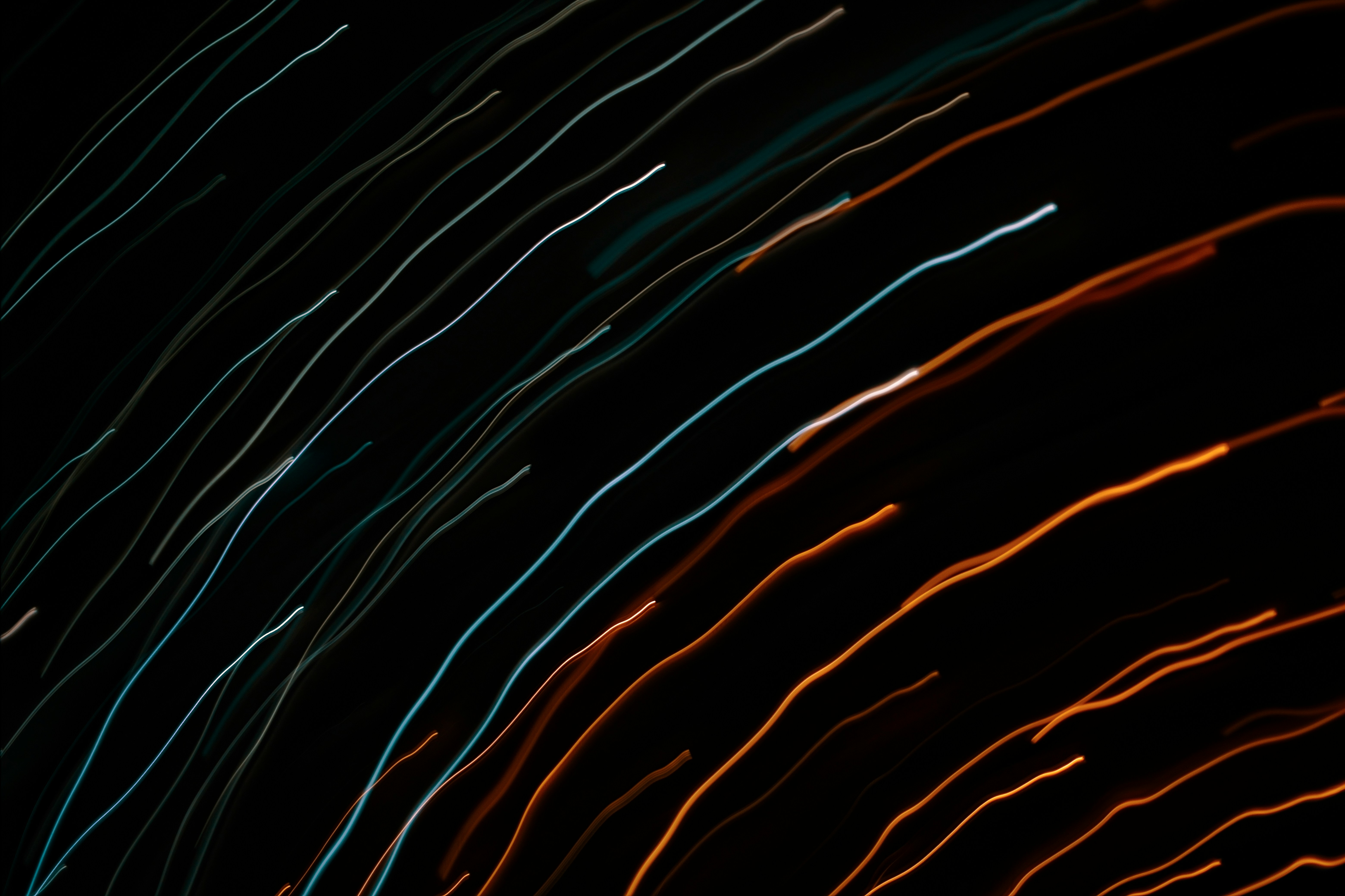 Abstract streaks of light against a dark background.