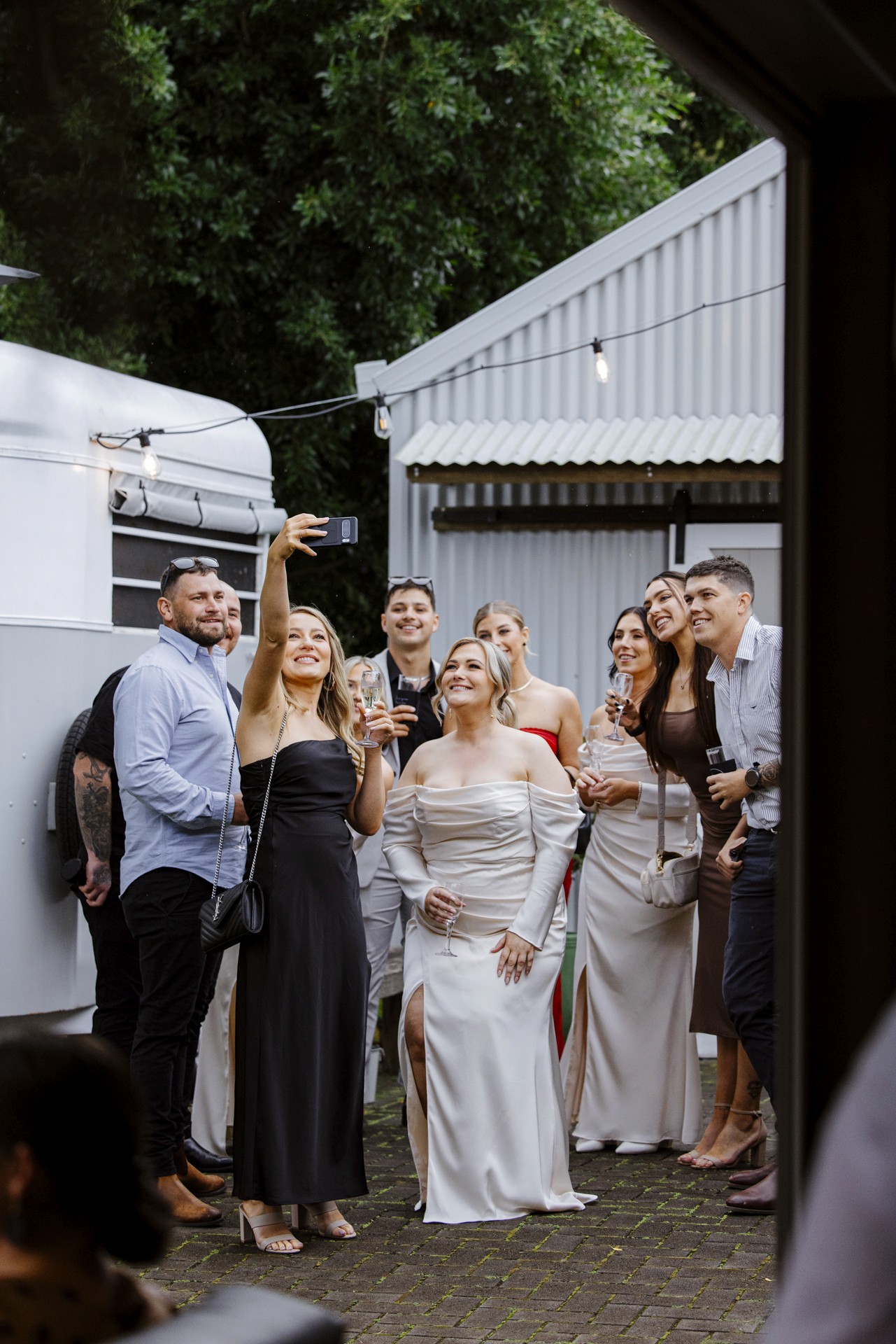 Group of wedding guests taking selfie together