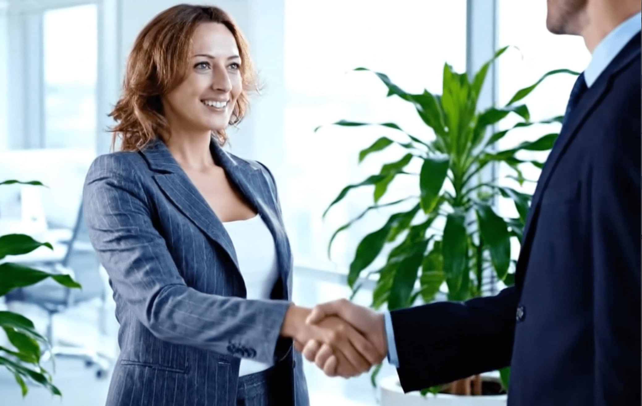Professional woman shaking hands in a spotless Coffs Harbour office maintained by Pacific Breeze Cleaners, reflecting a clean and professional impression.