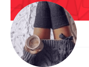 The image shows a person in gray knitwear, holding a warm drink, with crossed legs and thigh-high socks.