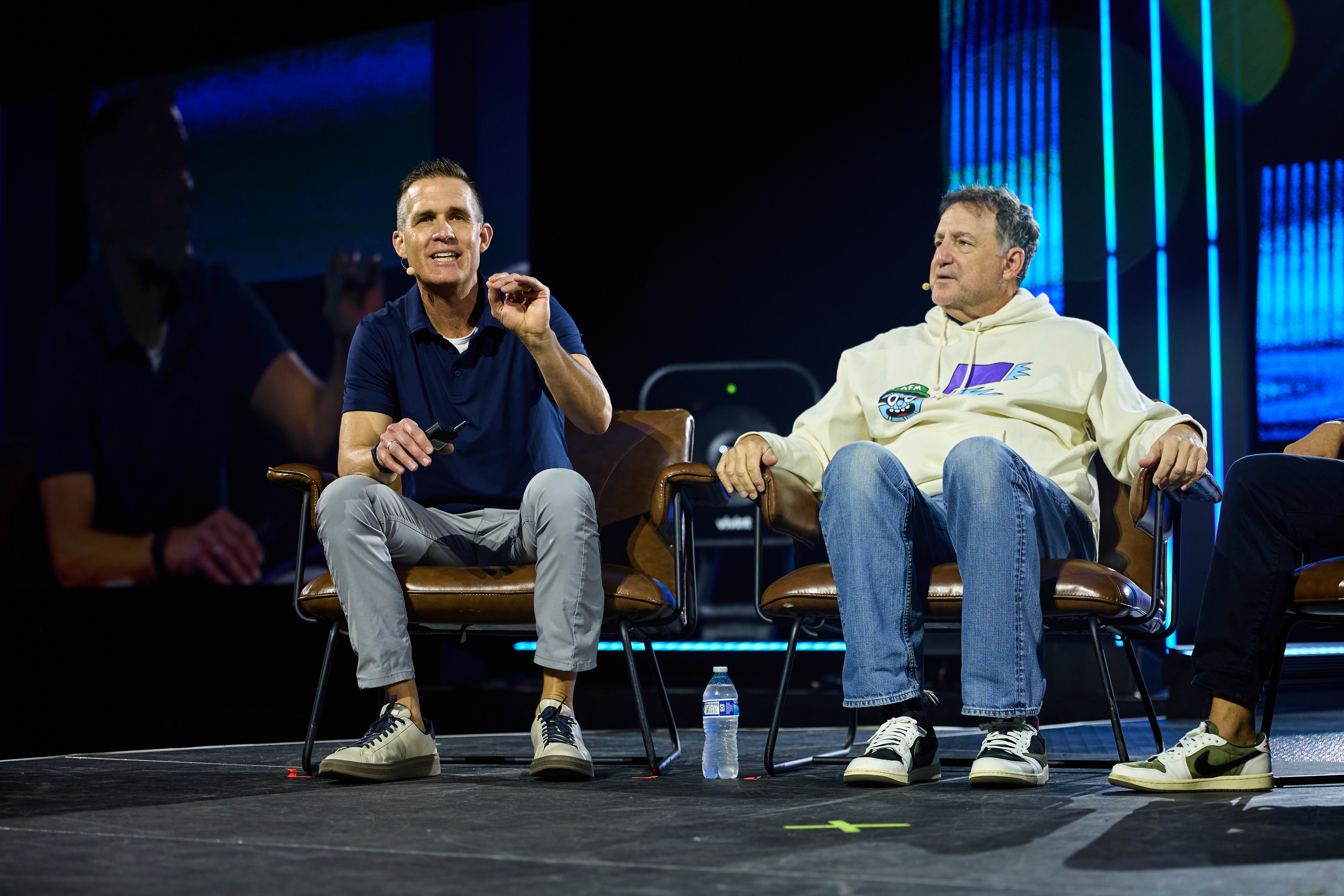 An orange cube-shaped side table is shown.