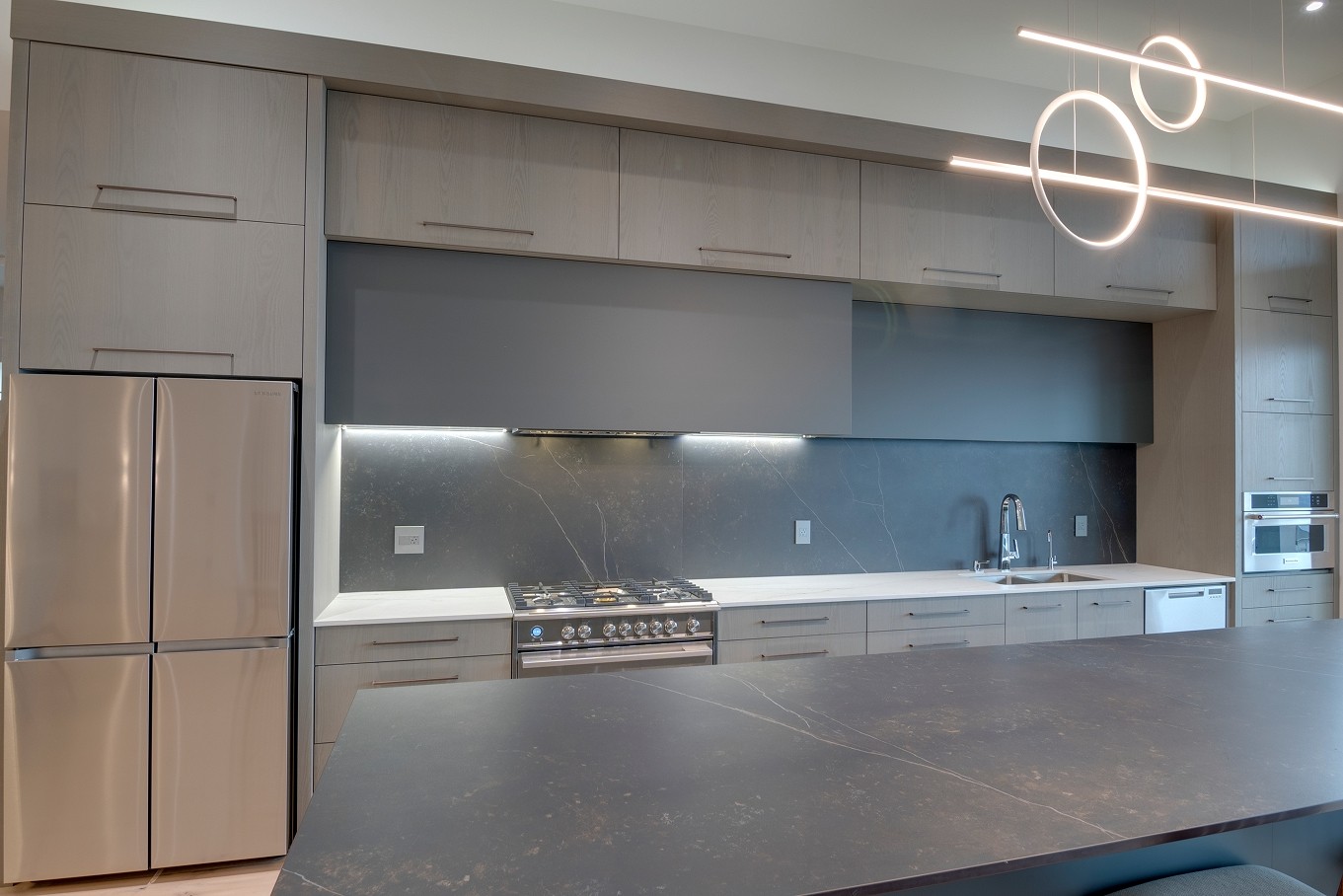 Contemporary kitchen with under-cabinet lighting and matte finishes