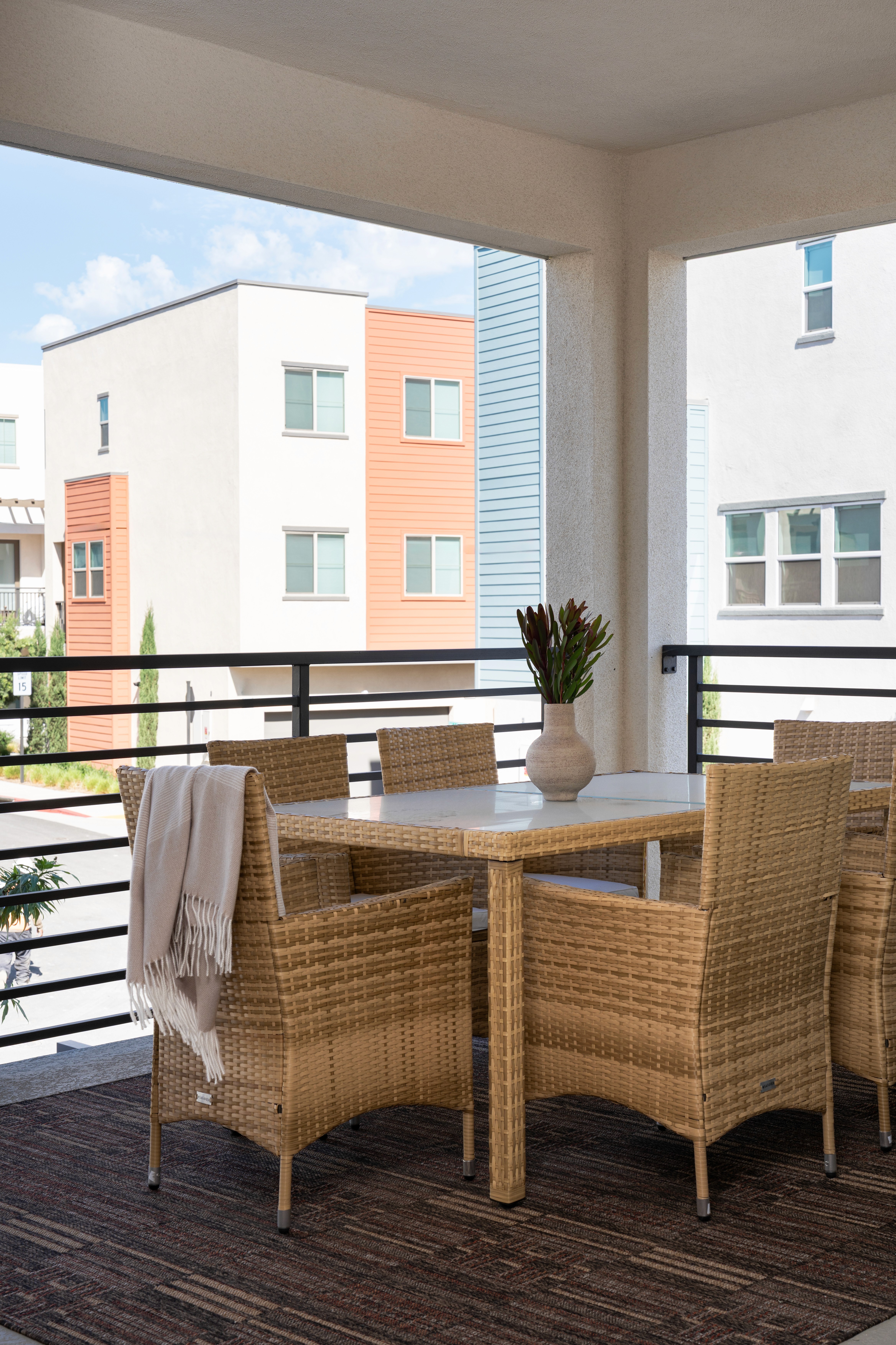 Balcony with table, chairs and greenery