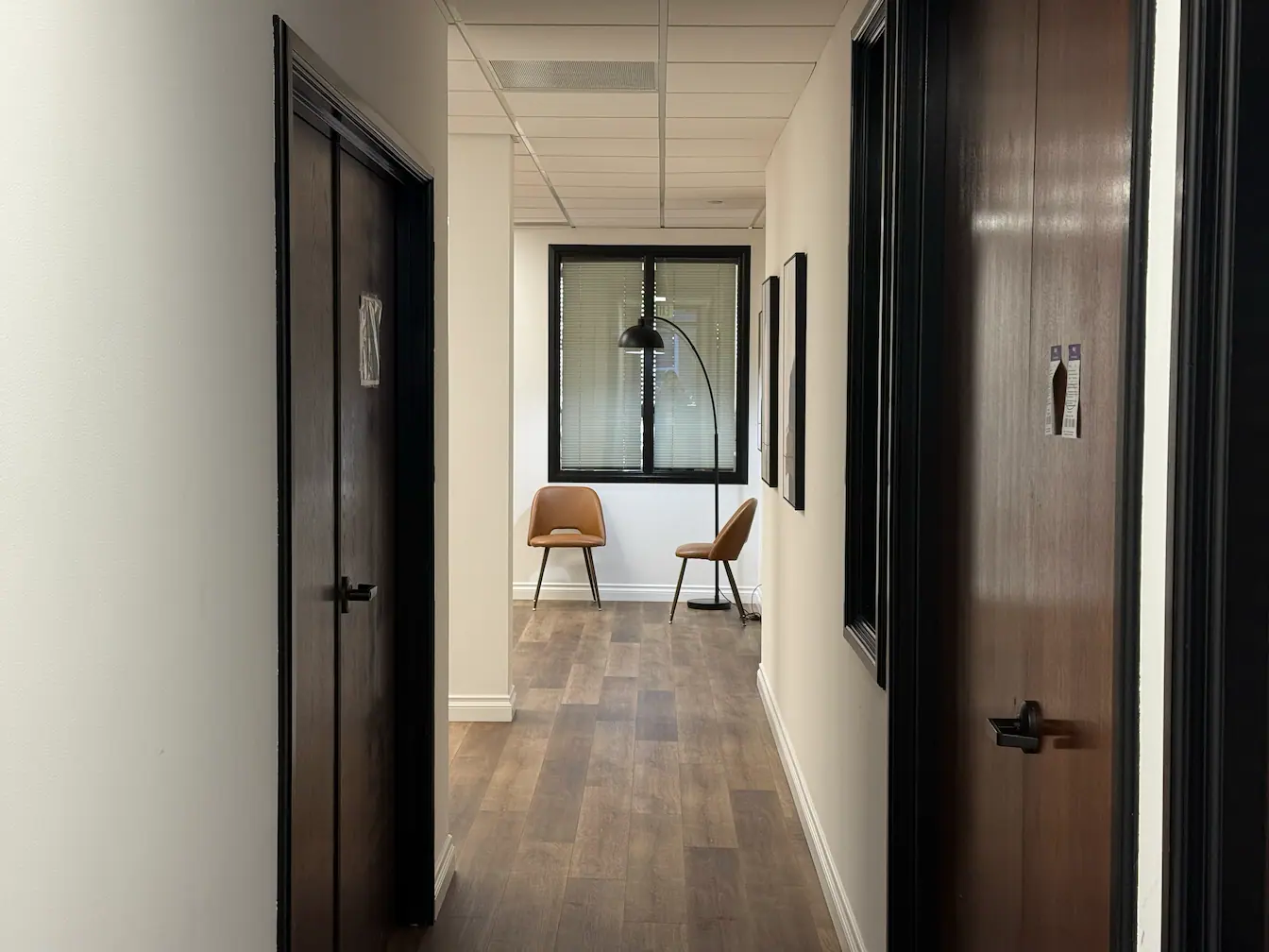 Light-filled hallway with framed beauty quotes on walls