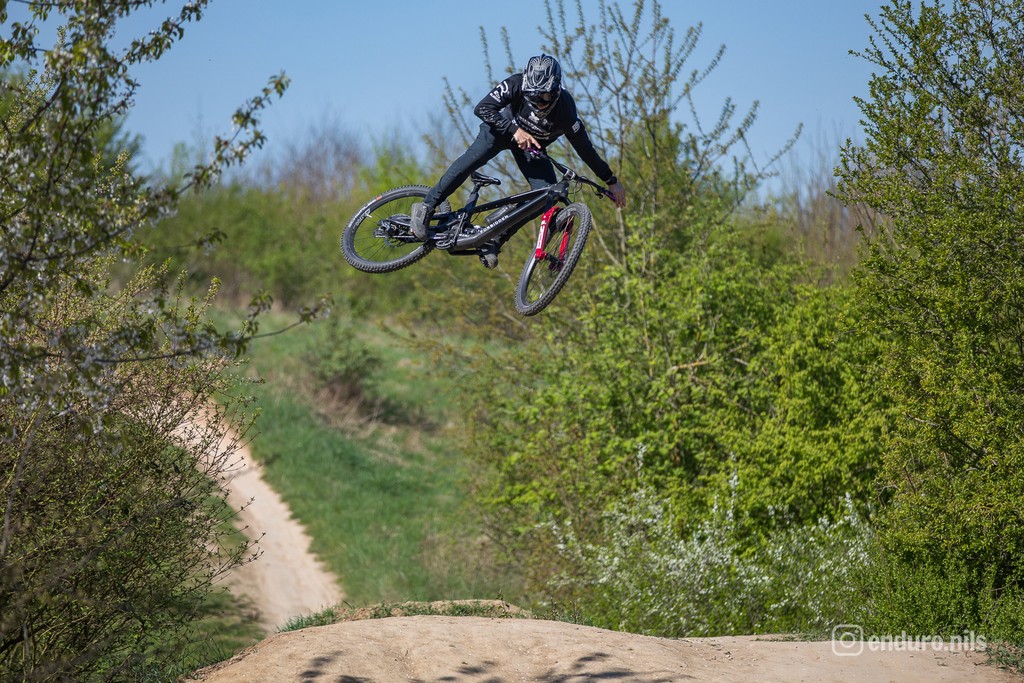 two young boys are playing tennis on a court