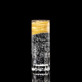 A closeup of a The Neon Strip drink against a dark background.