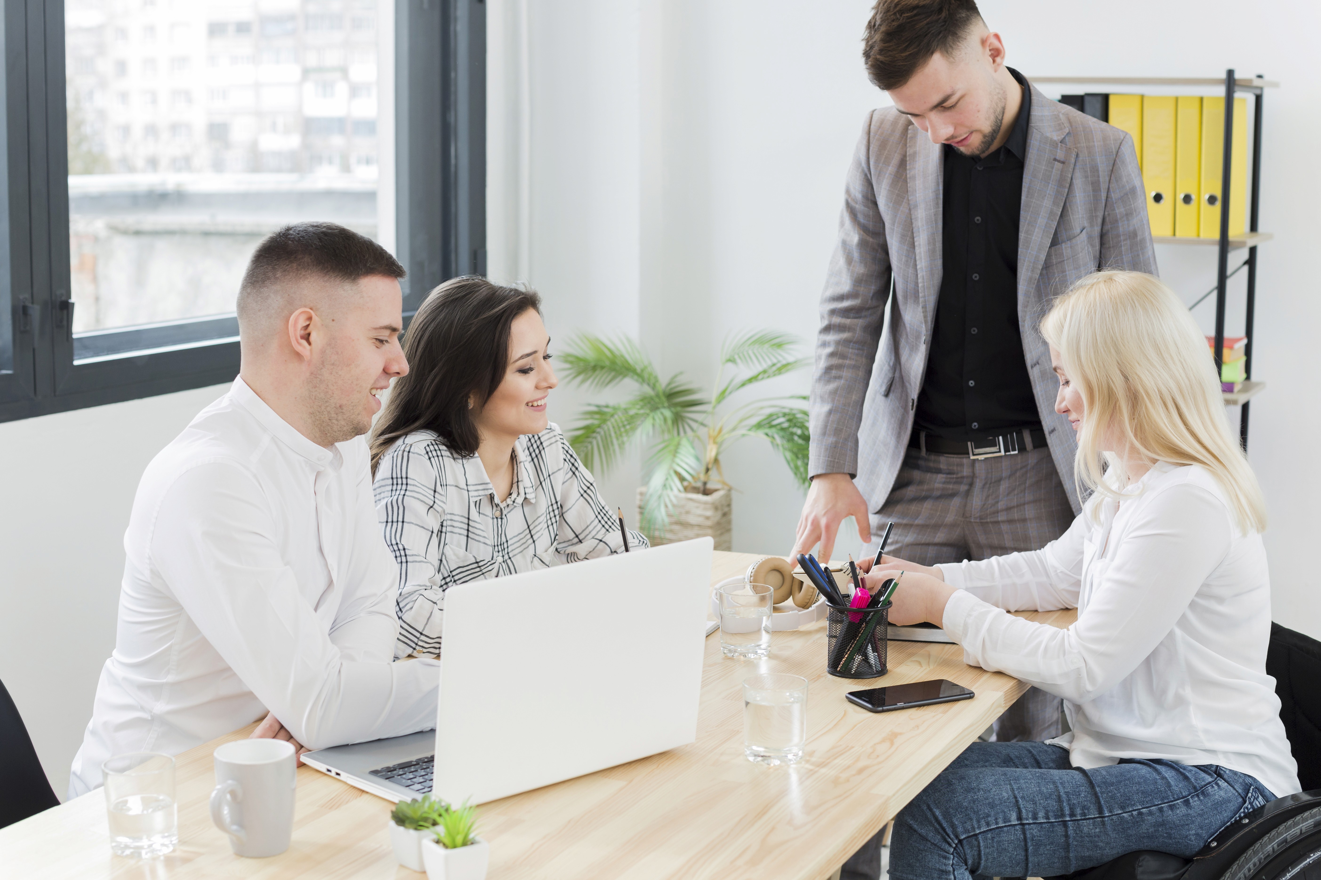 Balanced team interaction around tech and hiring  team interaction around laptops