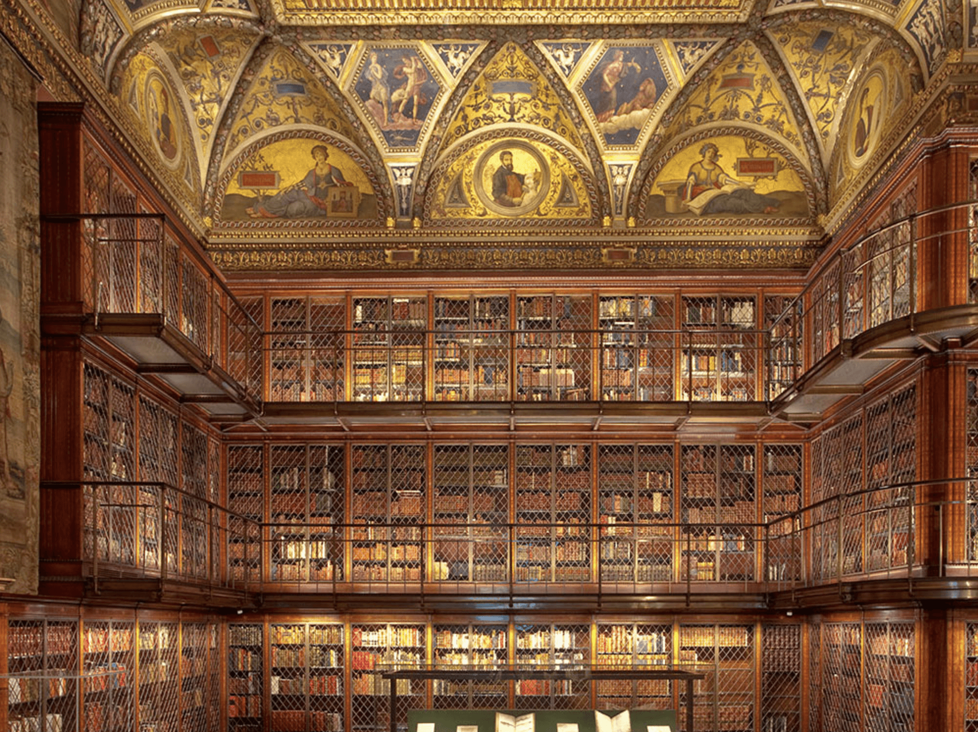 Ornate gilded ceiling and historic book-lined reading room at The Morgan Library & Museum in New York City