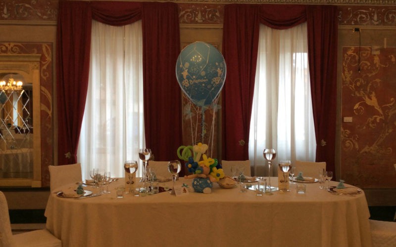 a person standing in a grass field with a large stone structure in the background