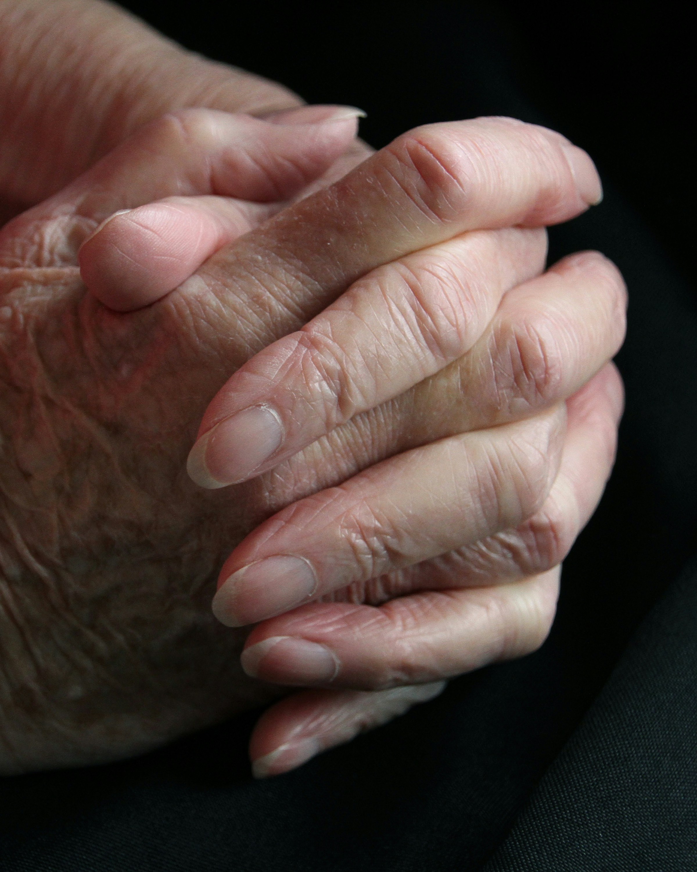 a close up of a person holding their hands together