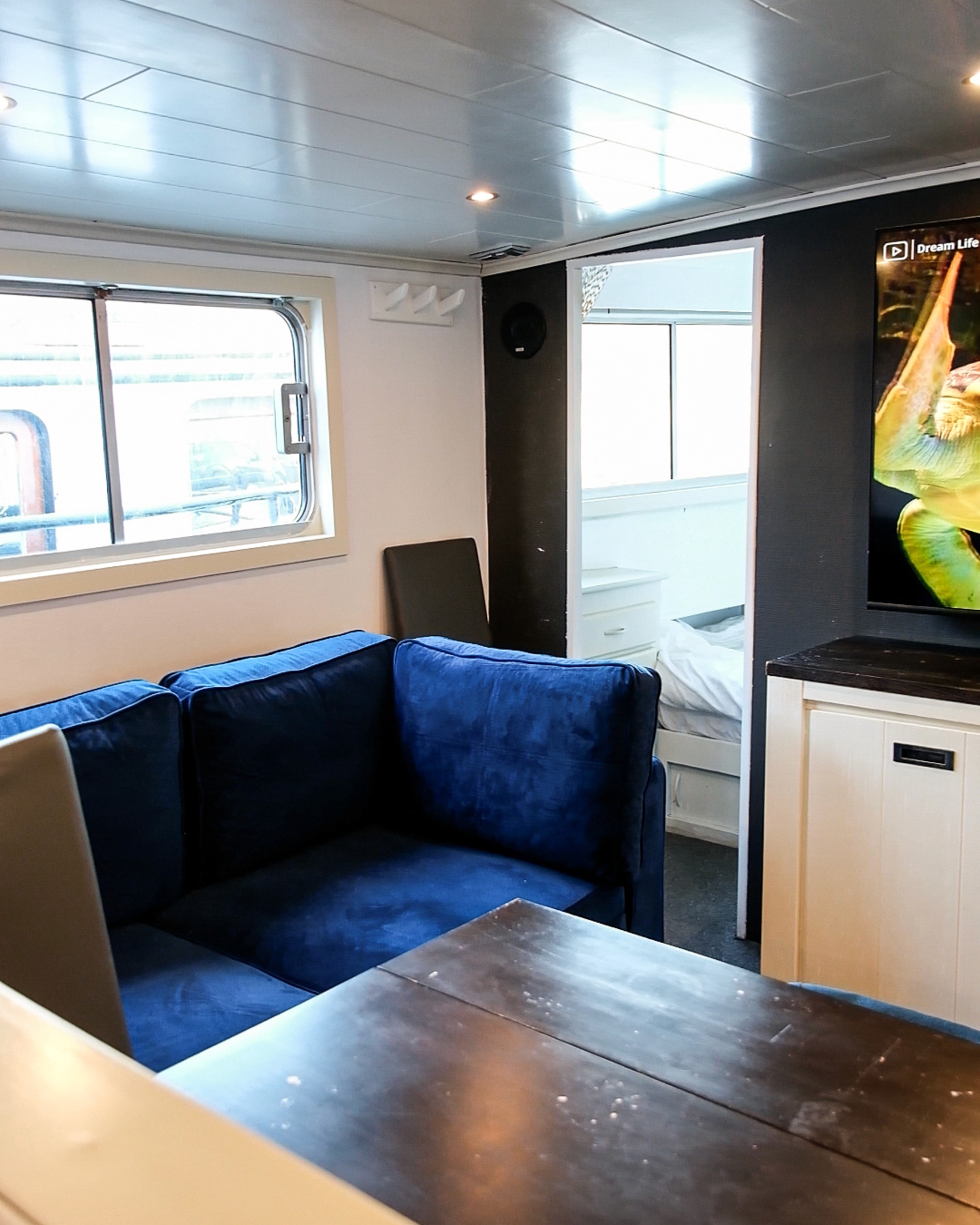 Gray sectional sofa with black coffee table and blue rug