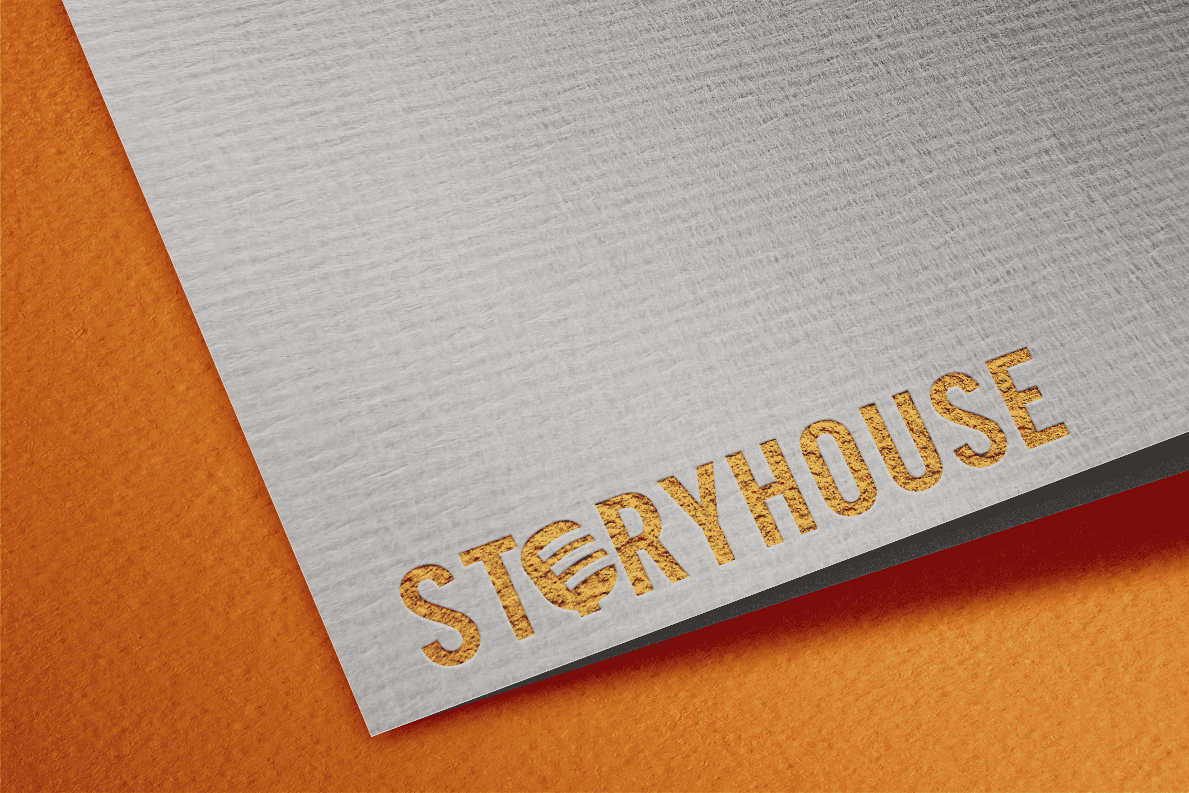 Close up of an embossed Storyhouse Media logo on textured material.