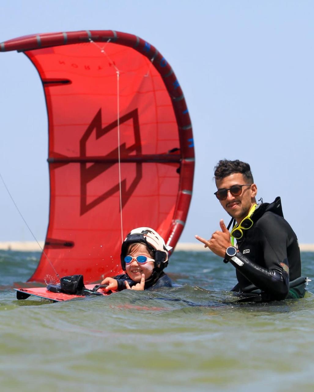A man standing with Sufboard
