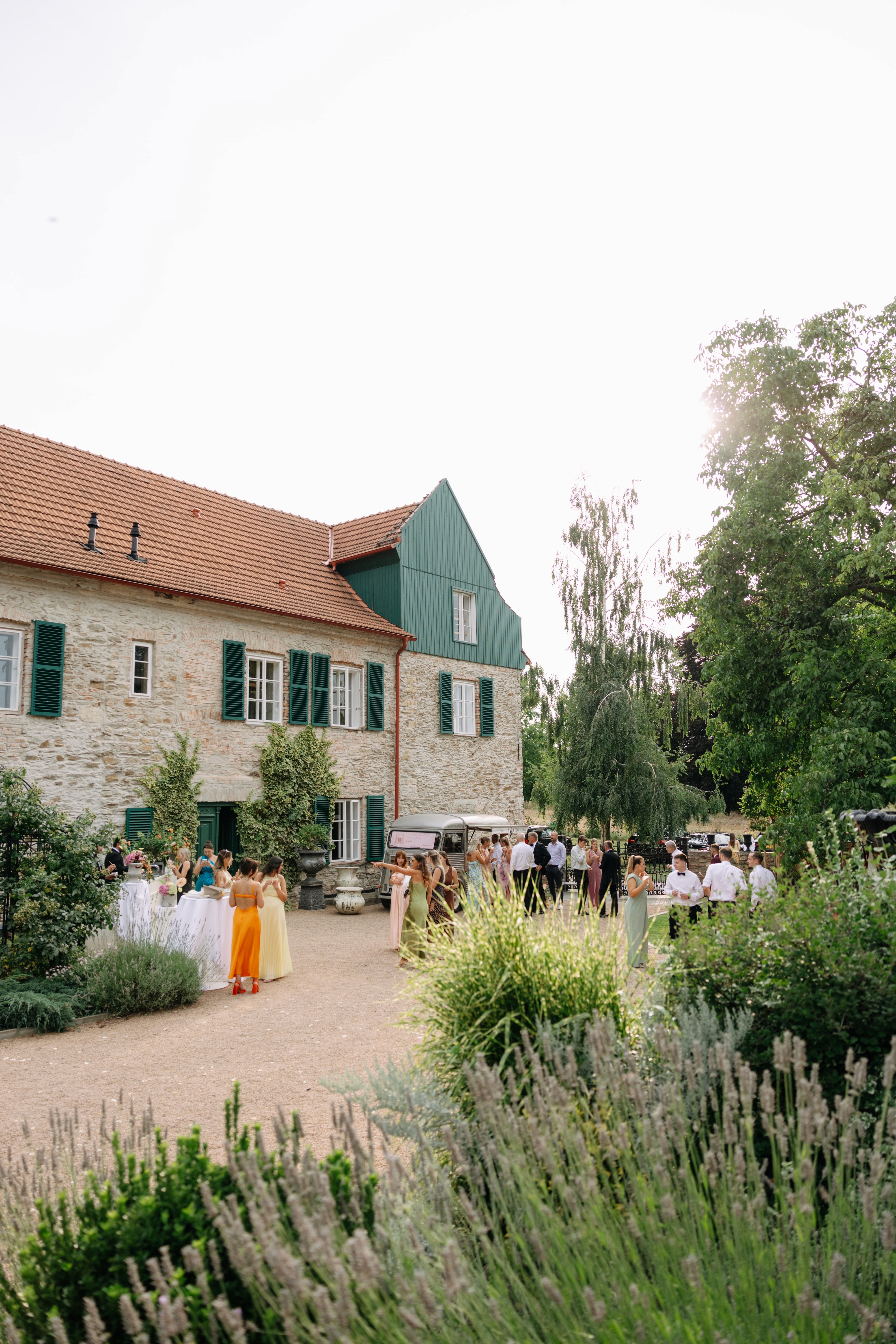 Exterior of a Tuscan-style villa surrounded by greenery — relaxed, rustic elegance.
