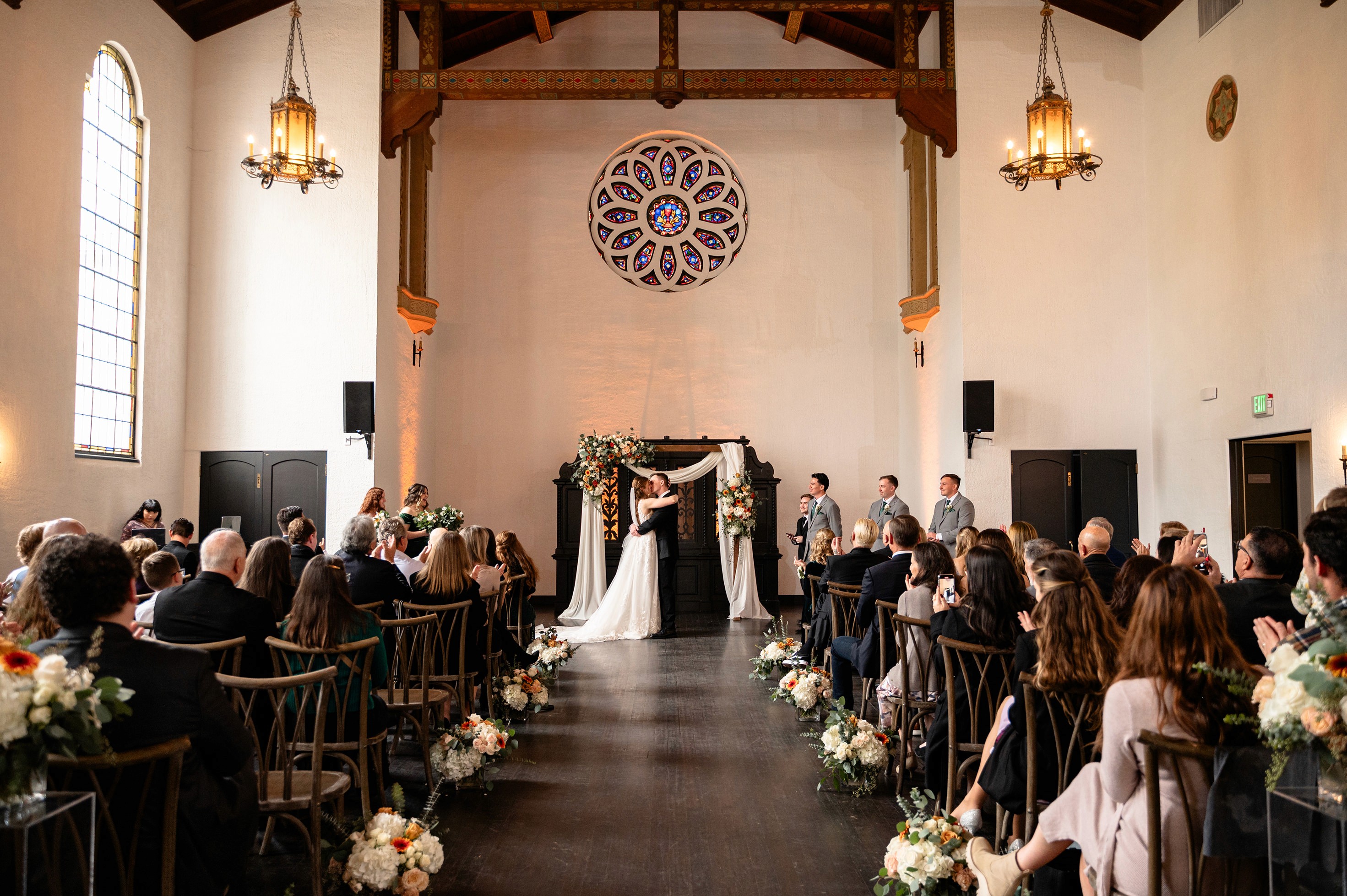 Flat lay wedding details with bouquet, rings, and sparkling bridal heels