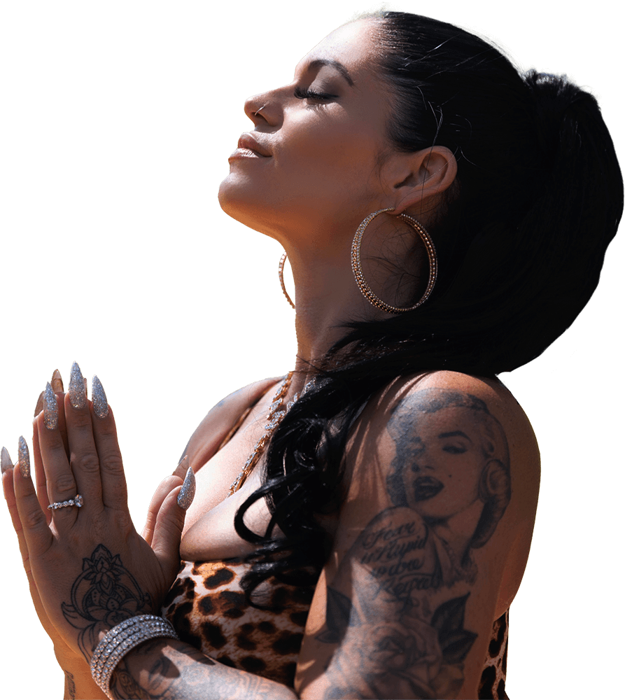 Gayle Fuller in prayer pose with eyes closed, wearing a leopard print top and gold jewelry, radiating peace, power, and sacred feminine devotion