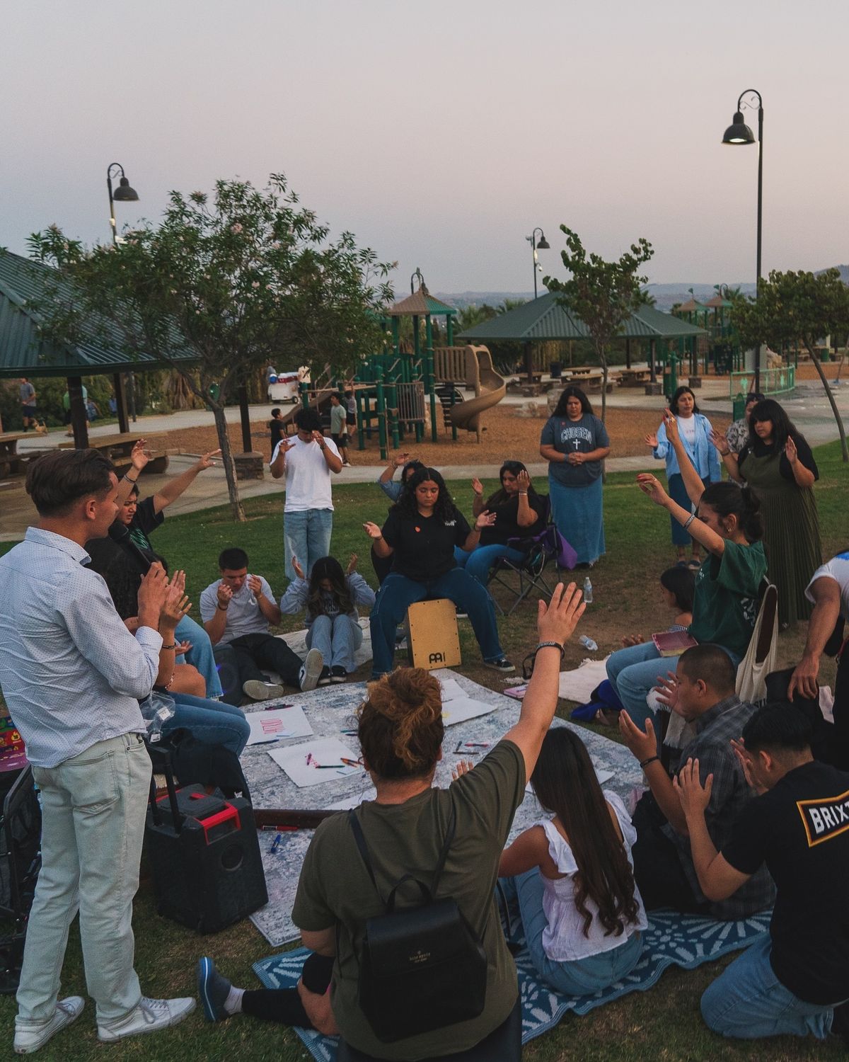 two people sitting at a table with laptops