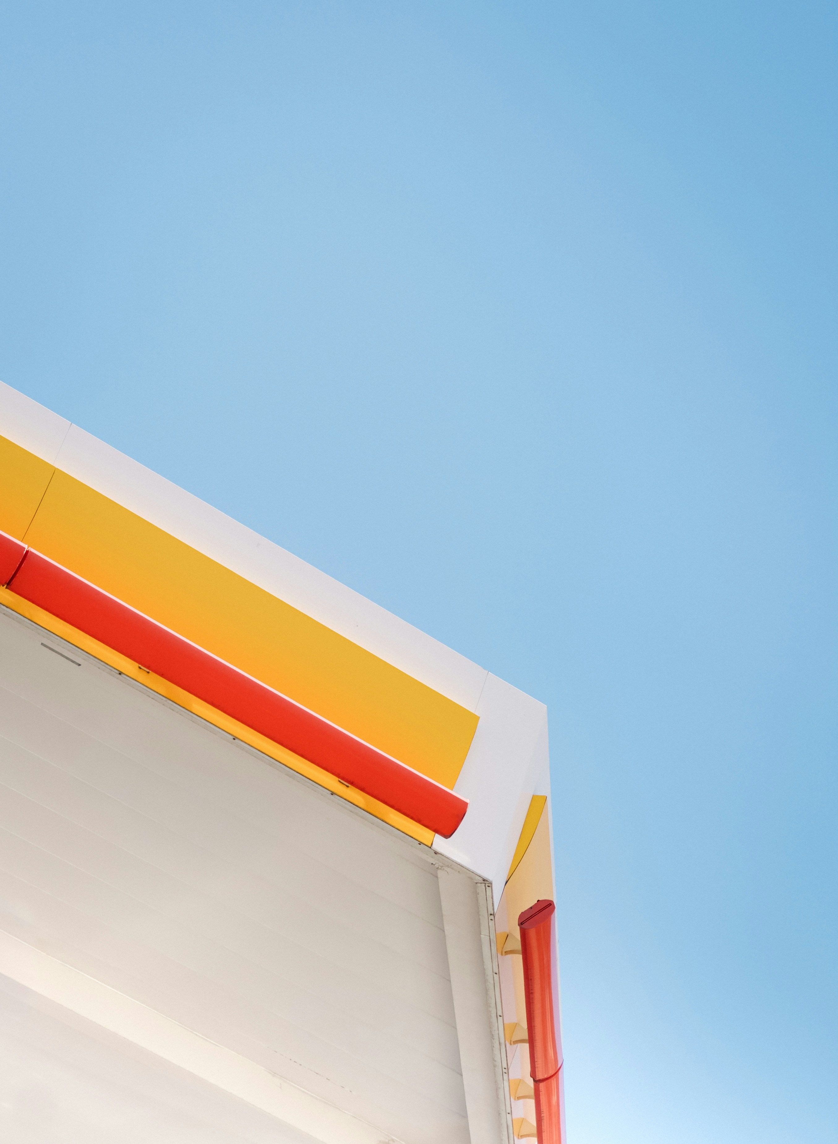 Modern building corner against a clear blue sky