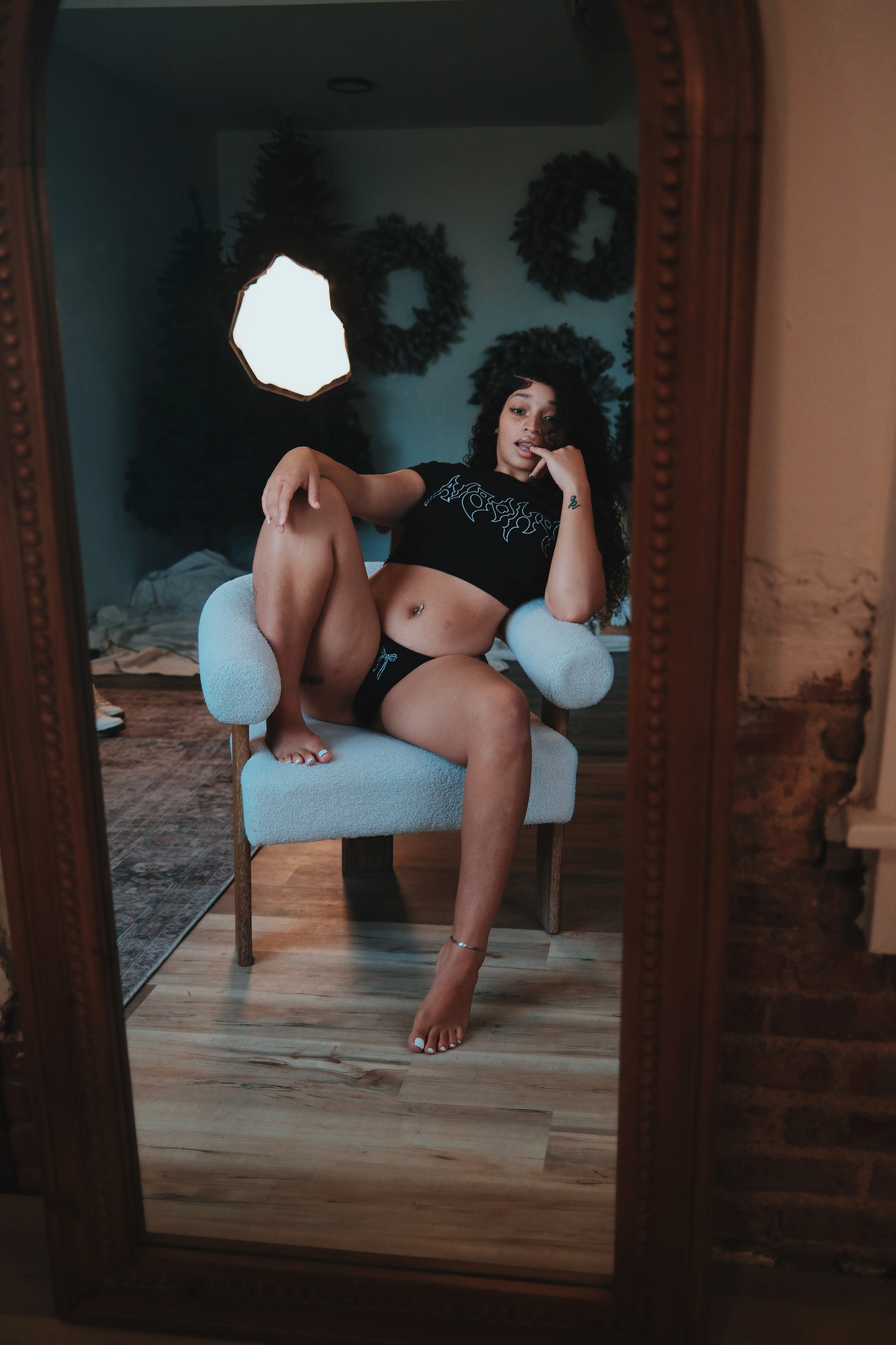 photo of girl posing with a cozy by mari crop top that say's phobia on the front