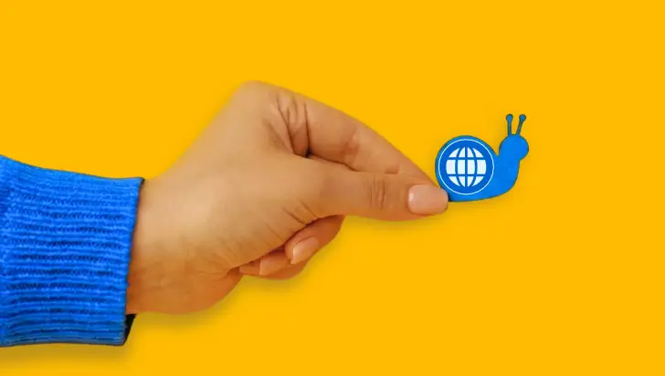 Hand holding a blue snail icon with a globe, representing slow website loading speed.