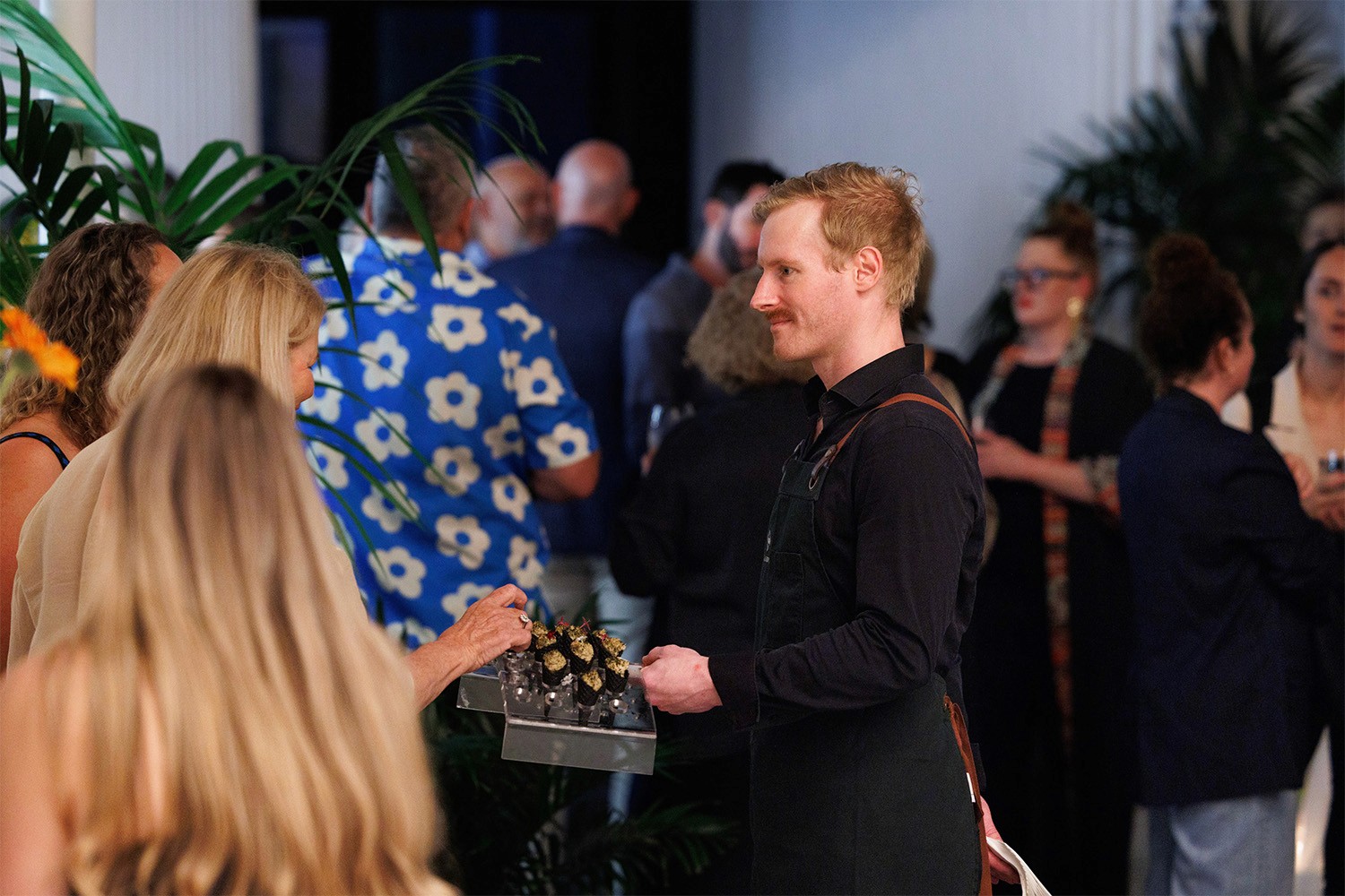 Waiter serving canapes in a cocktail function