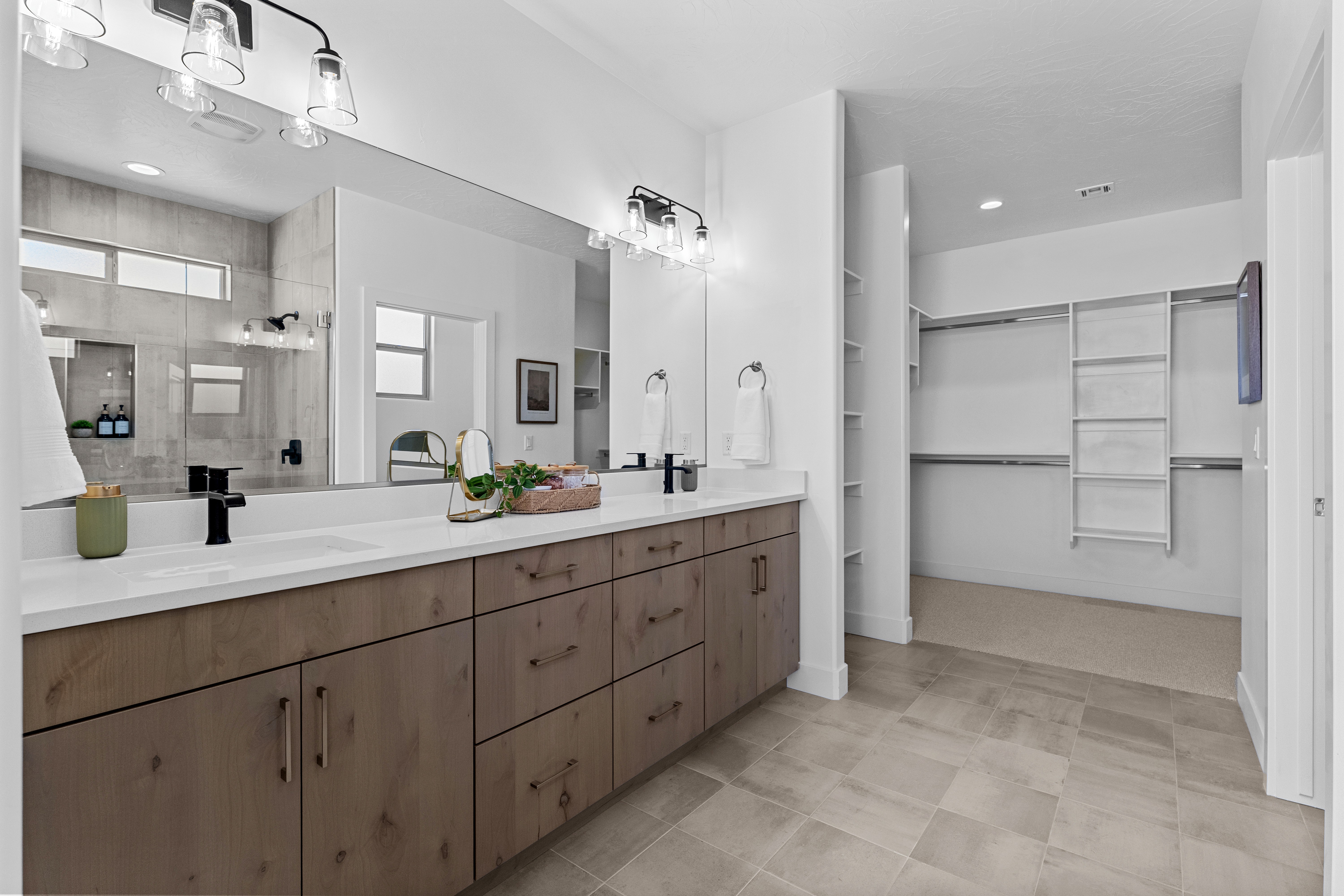 Master bathroom vanity of The Nest at Falcon Ridge in Hurricane, Utah, featuring double sinks and modern finishes.