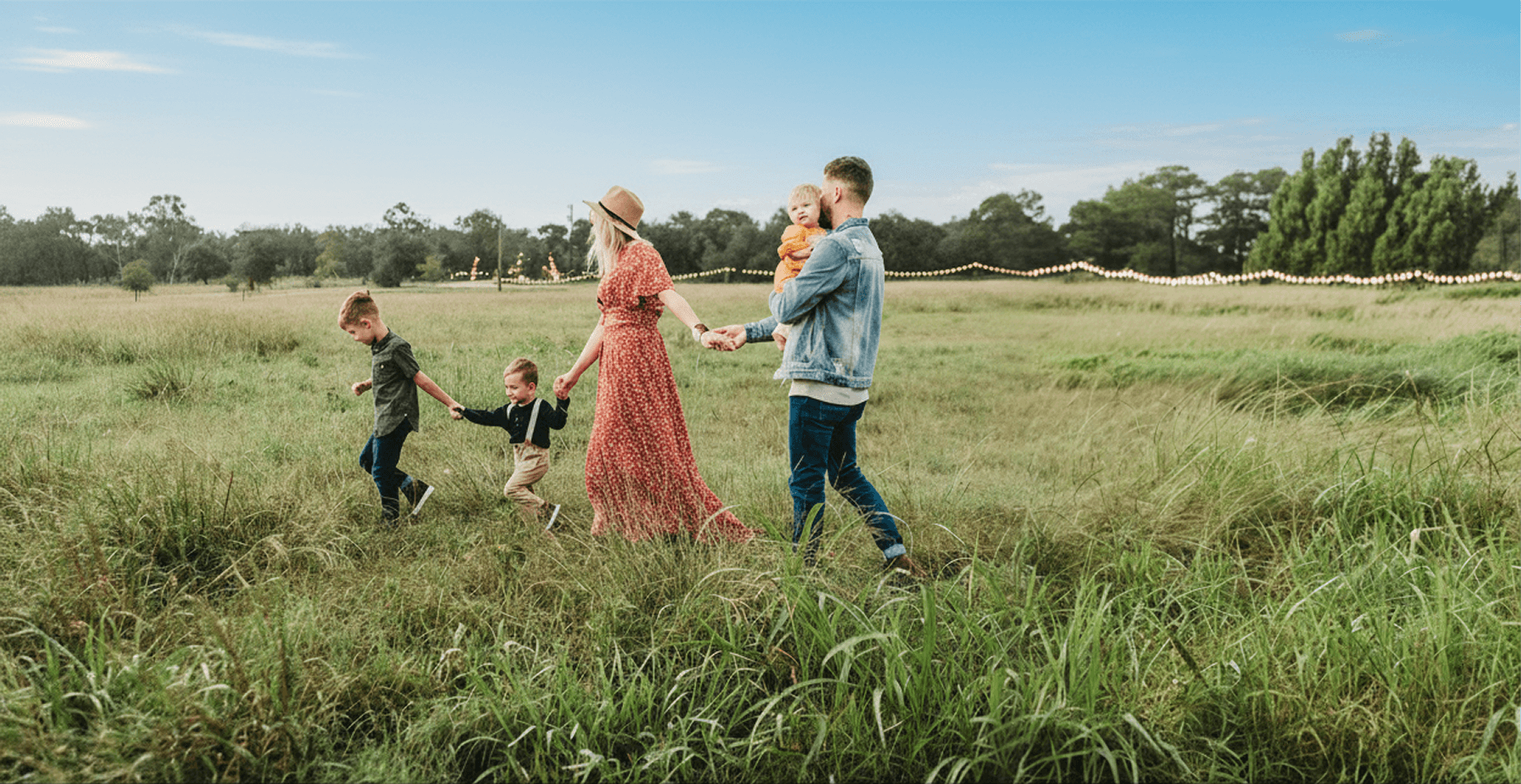 woman holding man and toddler hands during daytime