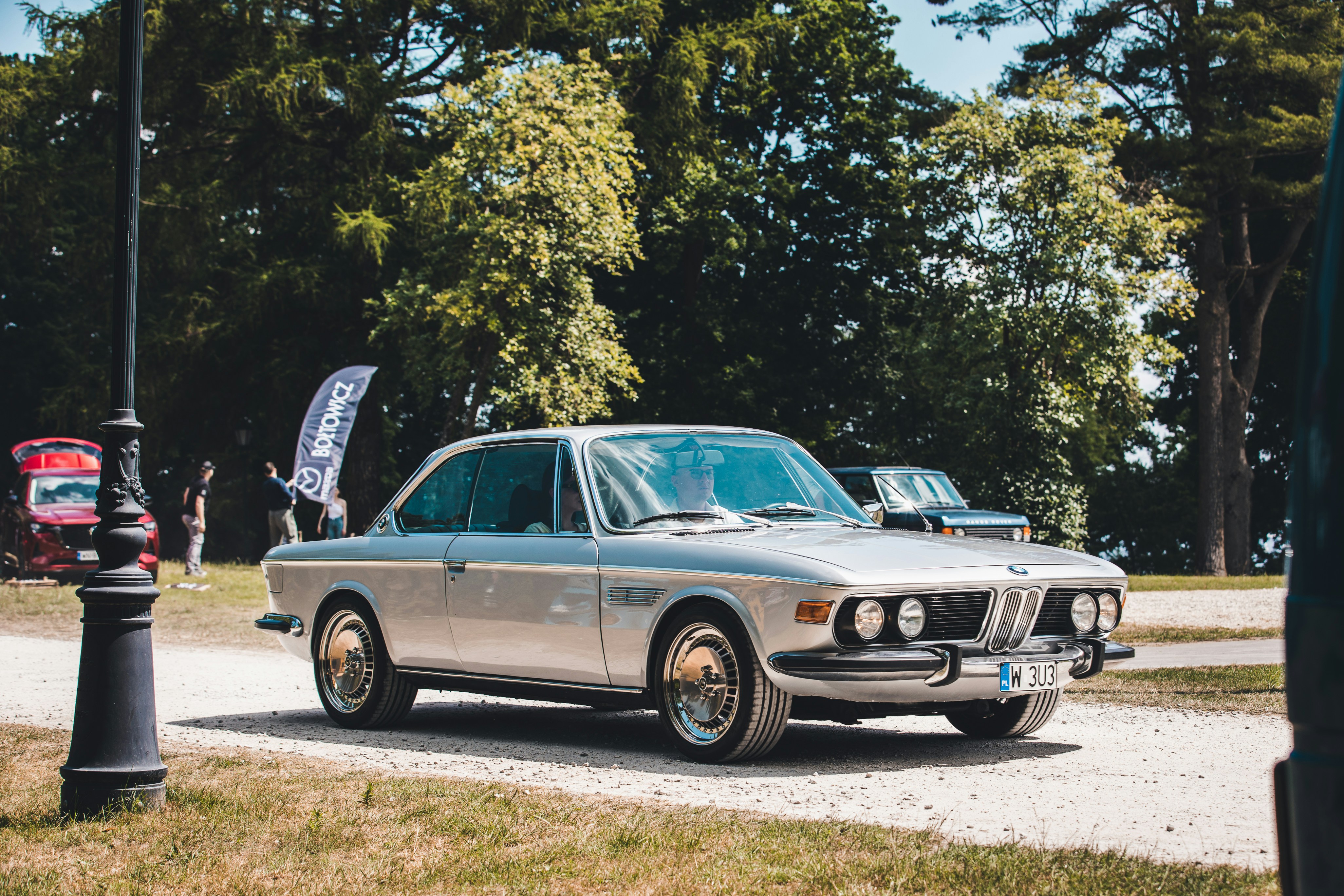 a silver car parked on the side of a road