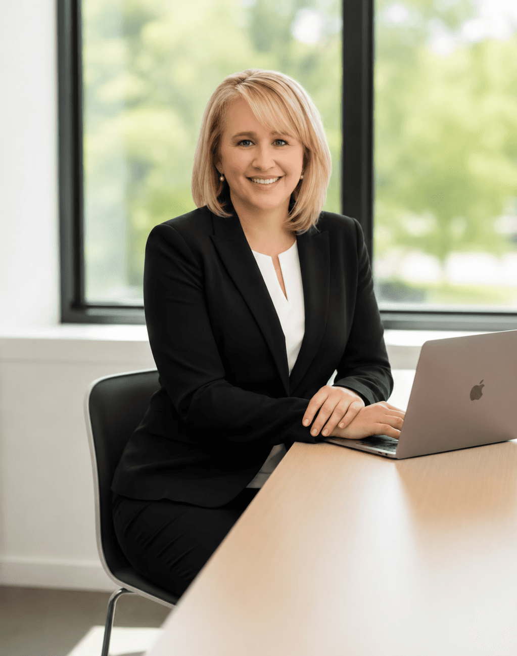 Alexandria Cordaie, Practice Manager at Cordaie Paralegal Services, seated at her desk in the firm's office.