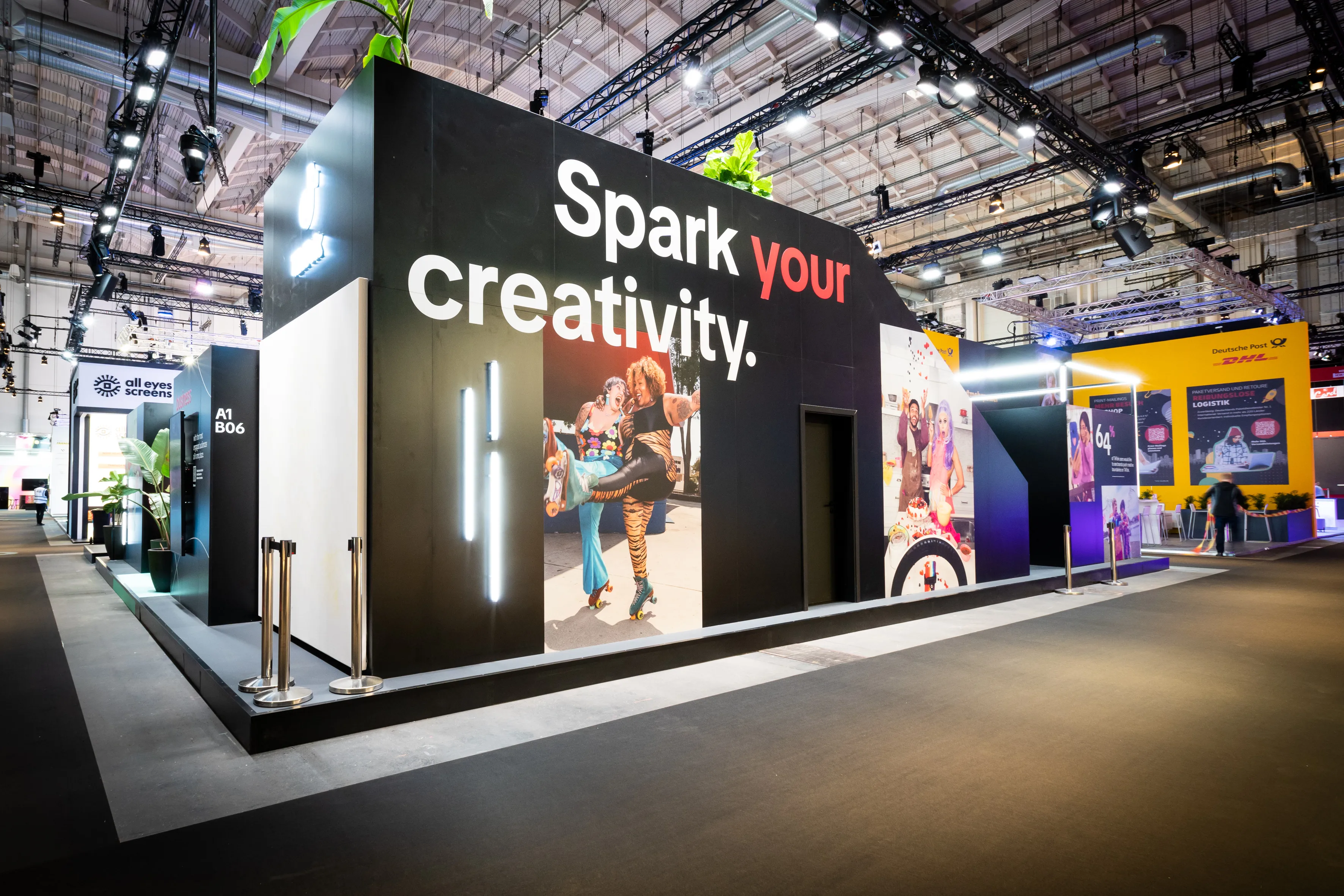 Booth facade with Spark Your Creativity lettering and large creator photos at the TikTok booth at OMR.