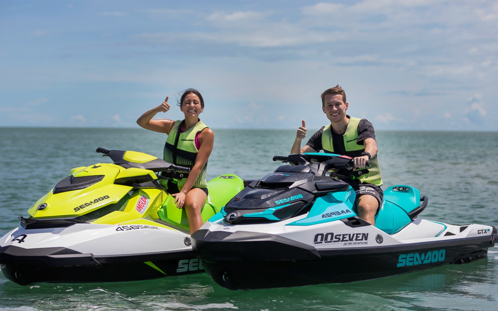 Jet ski riders giving thumbs up on a tour in Darwin waters.