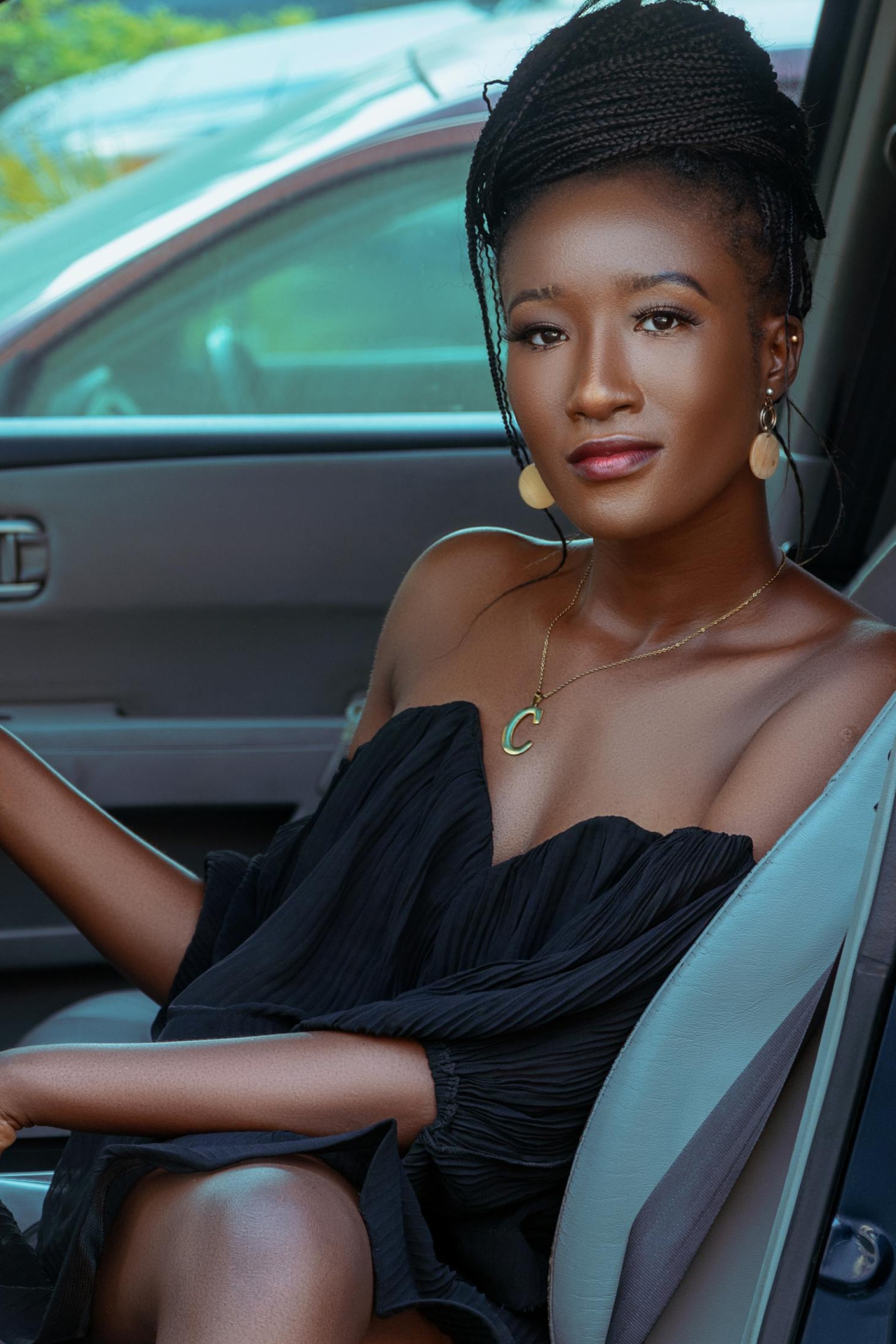 Woman sitting in her car bought at Car Dealership