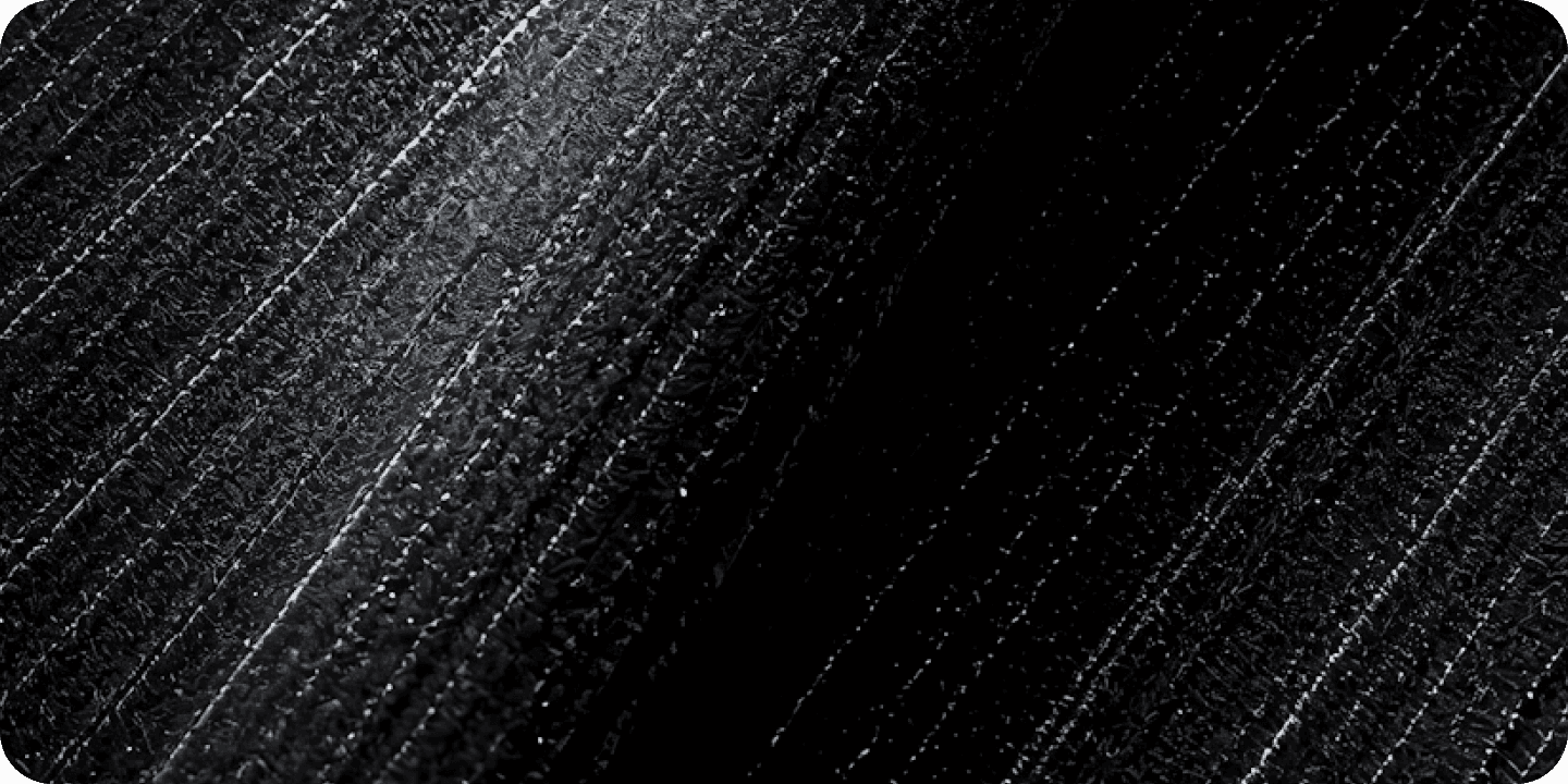 A high-contrast abstract background featuring black textured diagonal stripes with metallic silver highlights
