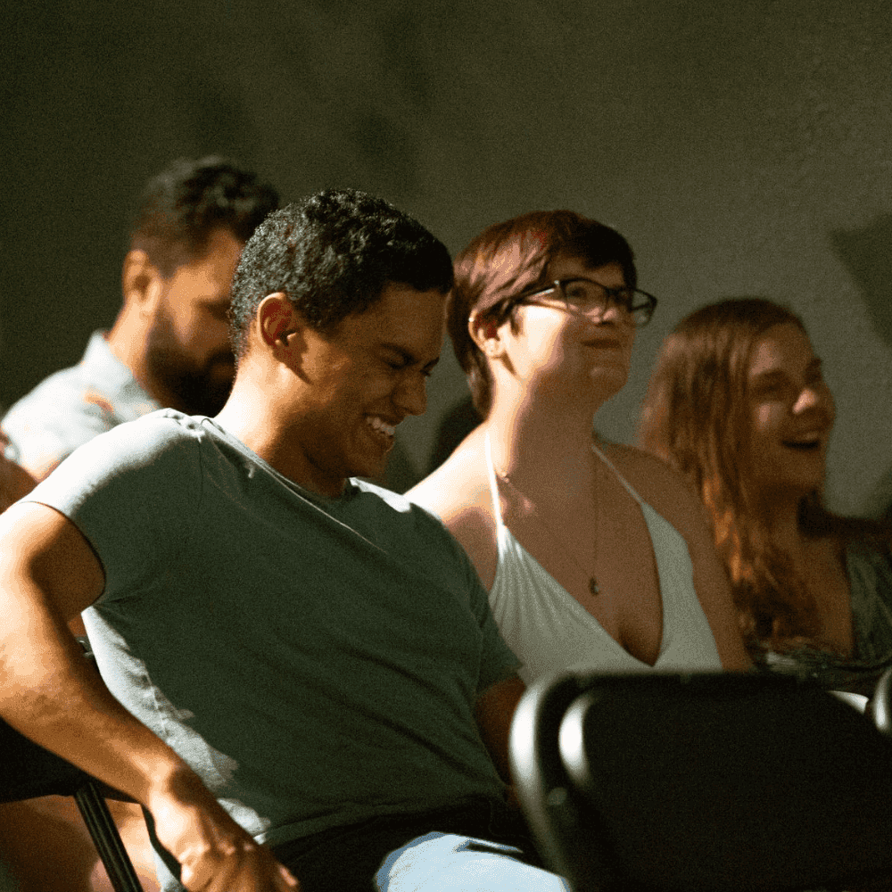 Audience members laughing during a St Pete Standup comedy show