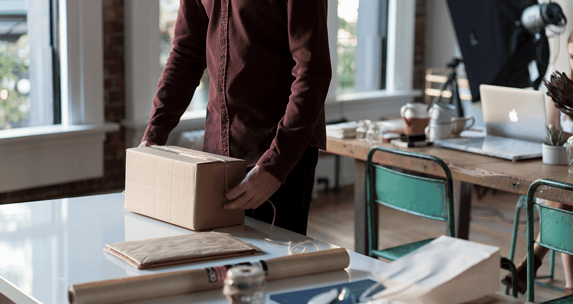 E-commerce owner packing parcel on a table