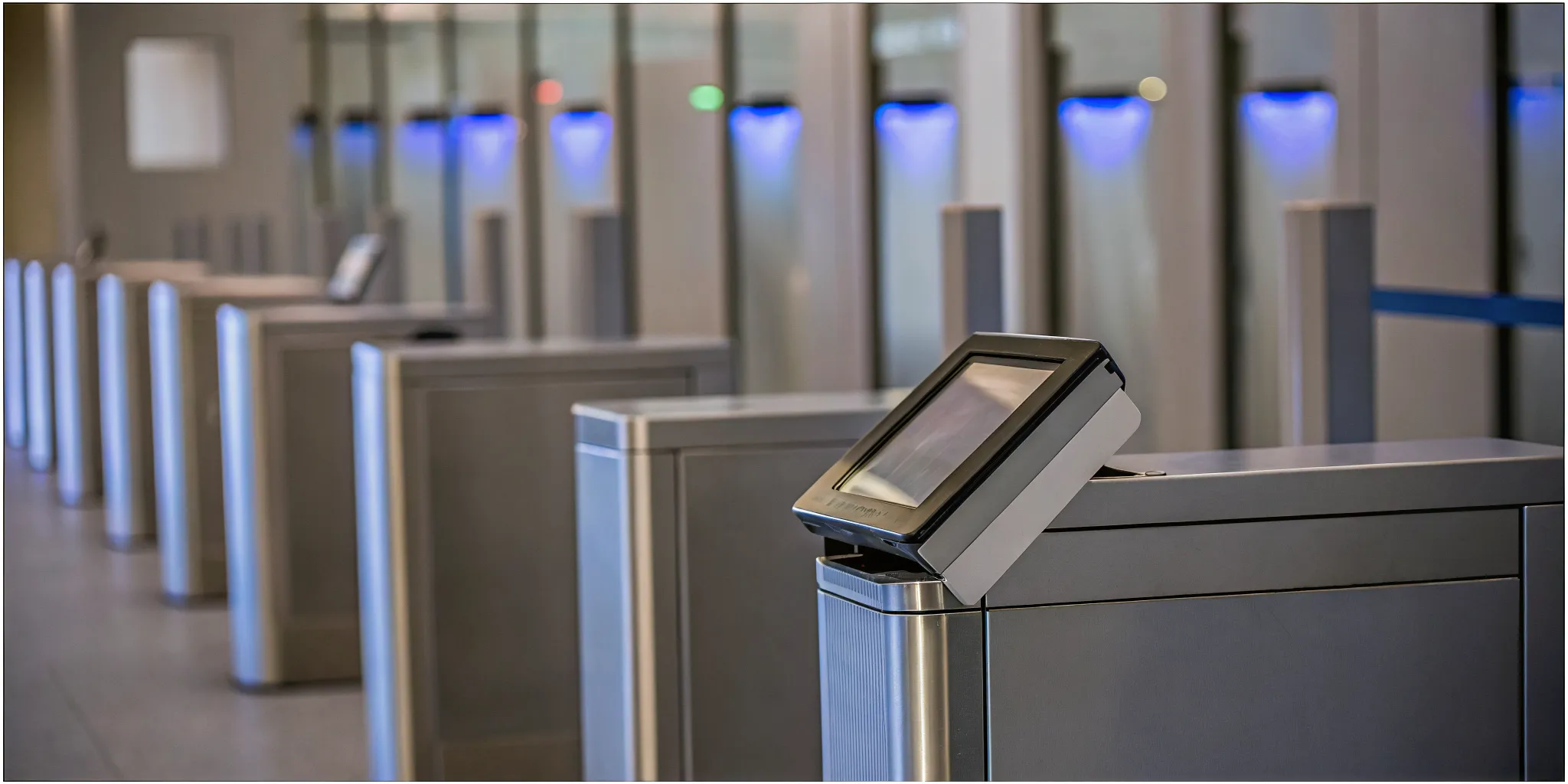 Self-service check-in kiosk displaying a digital visitor sign-in form beside a printed visitor badge in a corporate lobby