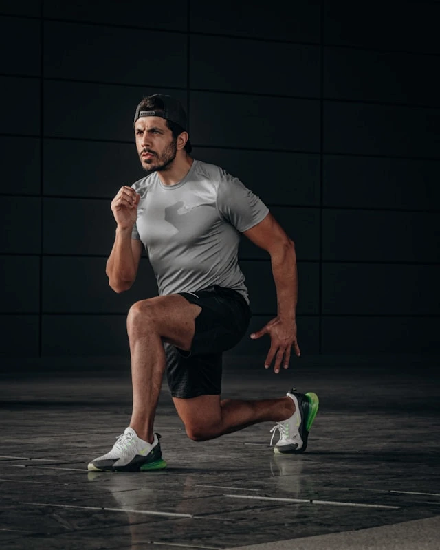 Man running indoors in athletic clothing