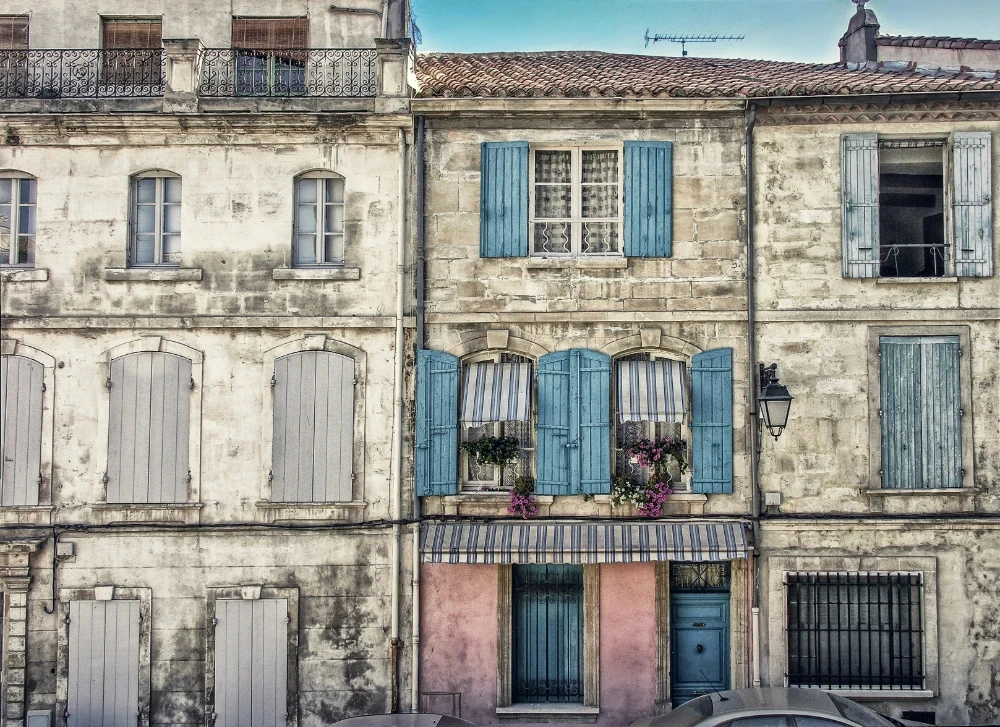 Old Provencal stone houses with blue shutters and flower boxes, southern France