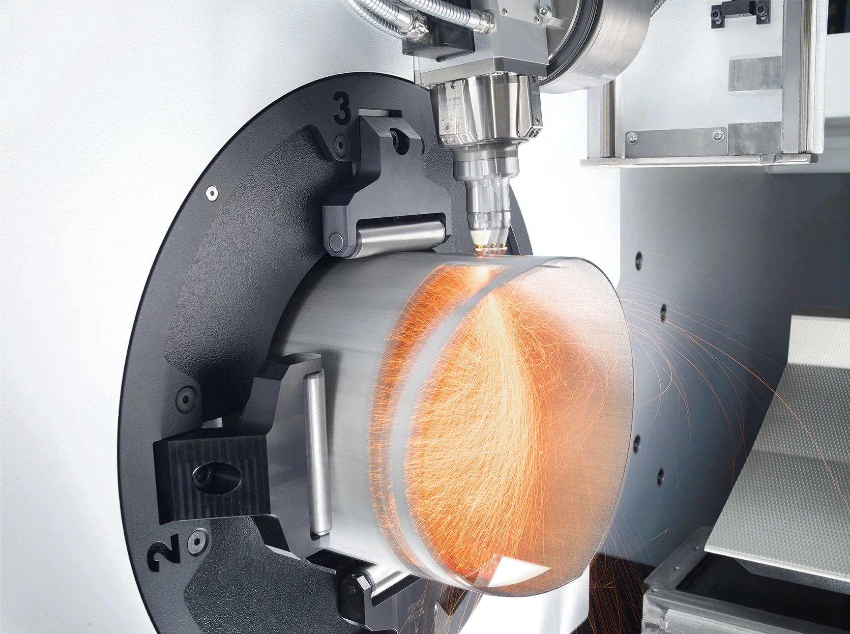 Tube laser machine cutting a round metal tube with high-precision laser technology.
