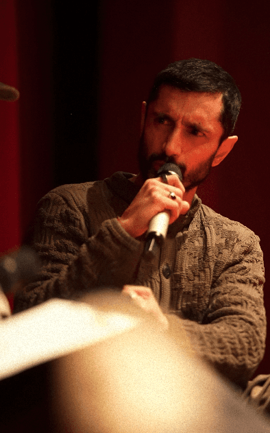 Bride in white dress walking on street, man in background
