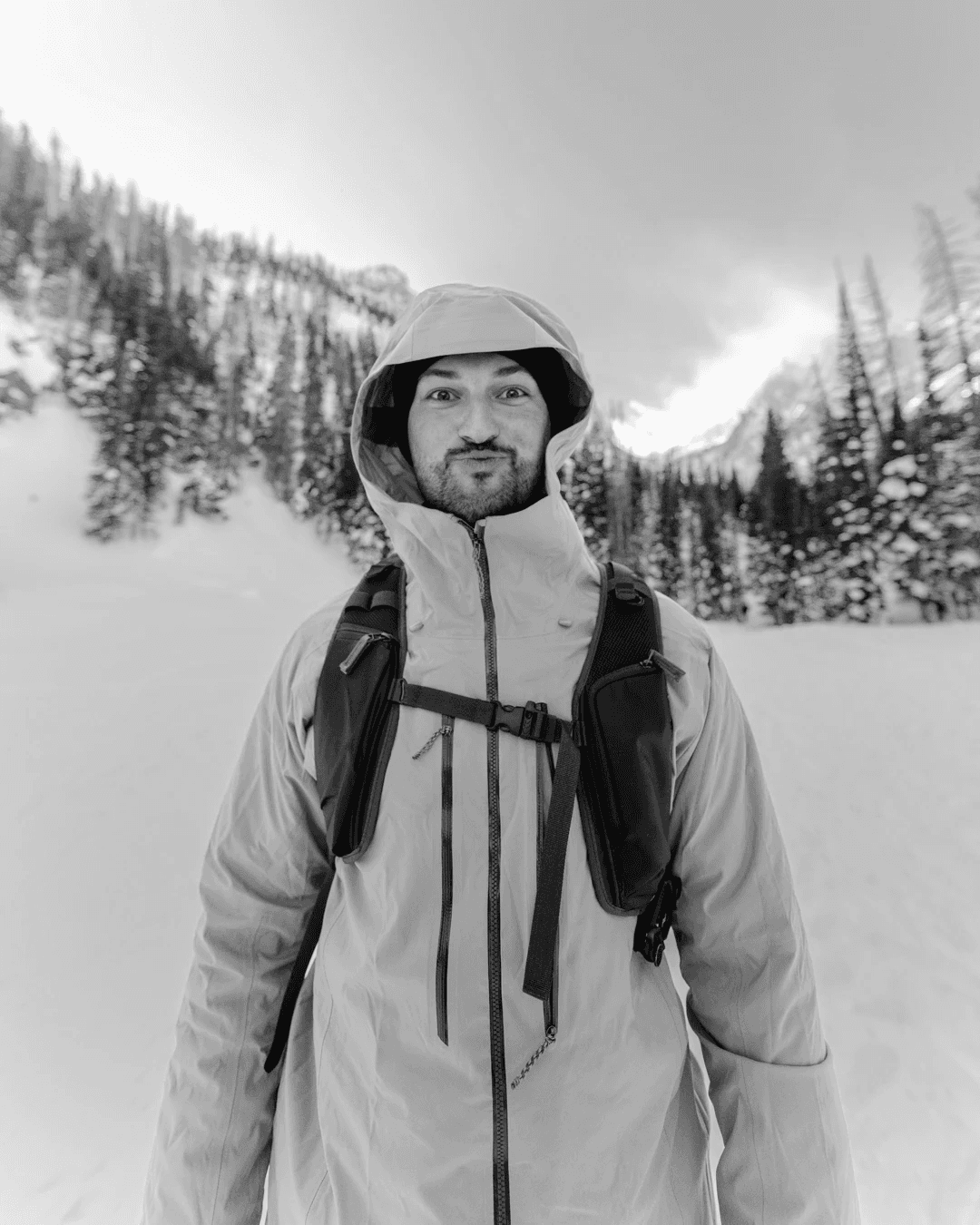 a photo of erick zajac standing in a winter mountain background