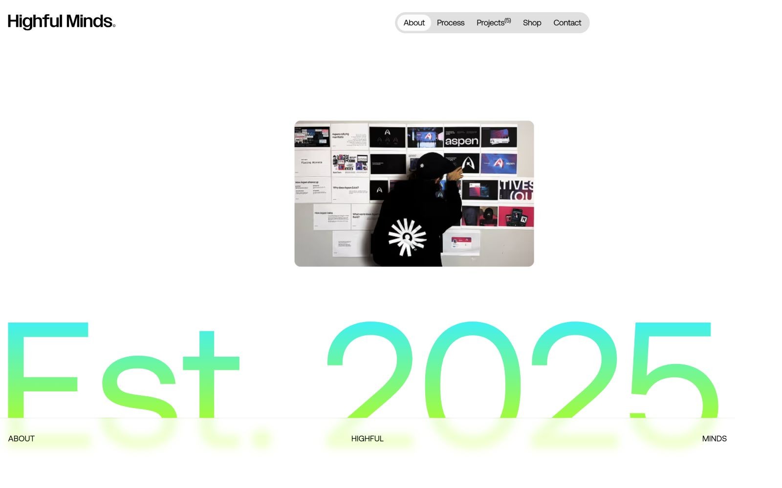 Minimalist website with "Highful Minds." Static background featuring "Est. 2025" in gradient text. Central video preview.
