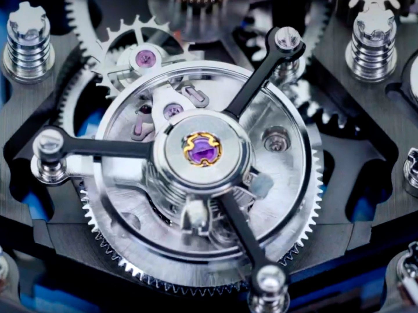 The image shows a close-up of an intricate mechanical watch movement featuring polished gears and a central, purple gemstone, highlighting the precision and craftsmanship of the Adriatica Tourbillon TV commercial design by Abarel