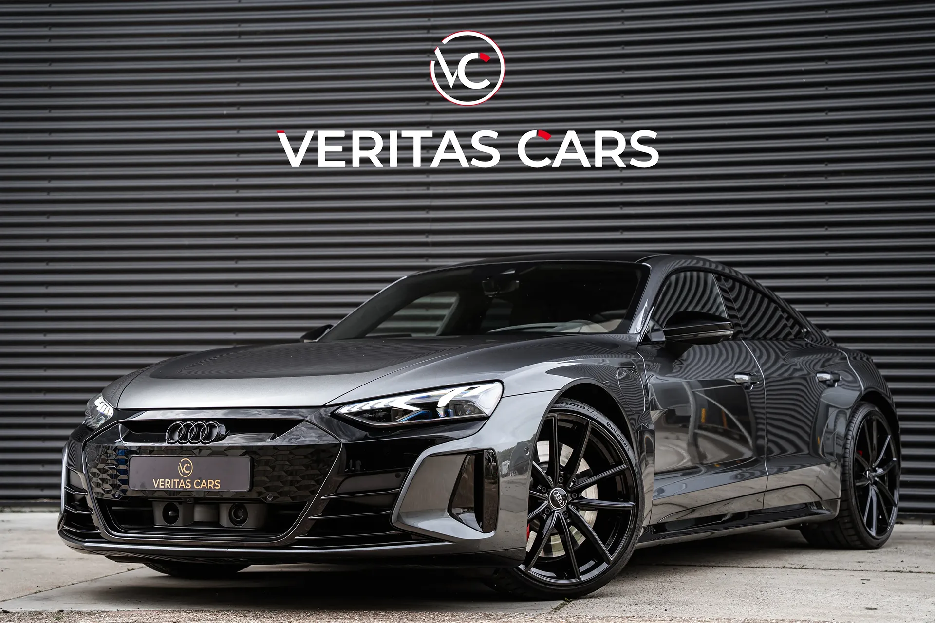 Frontside image of an Audi in front of a garage door