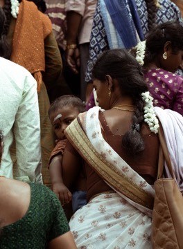 A woman in white moving through the crowd
