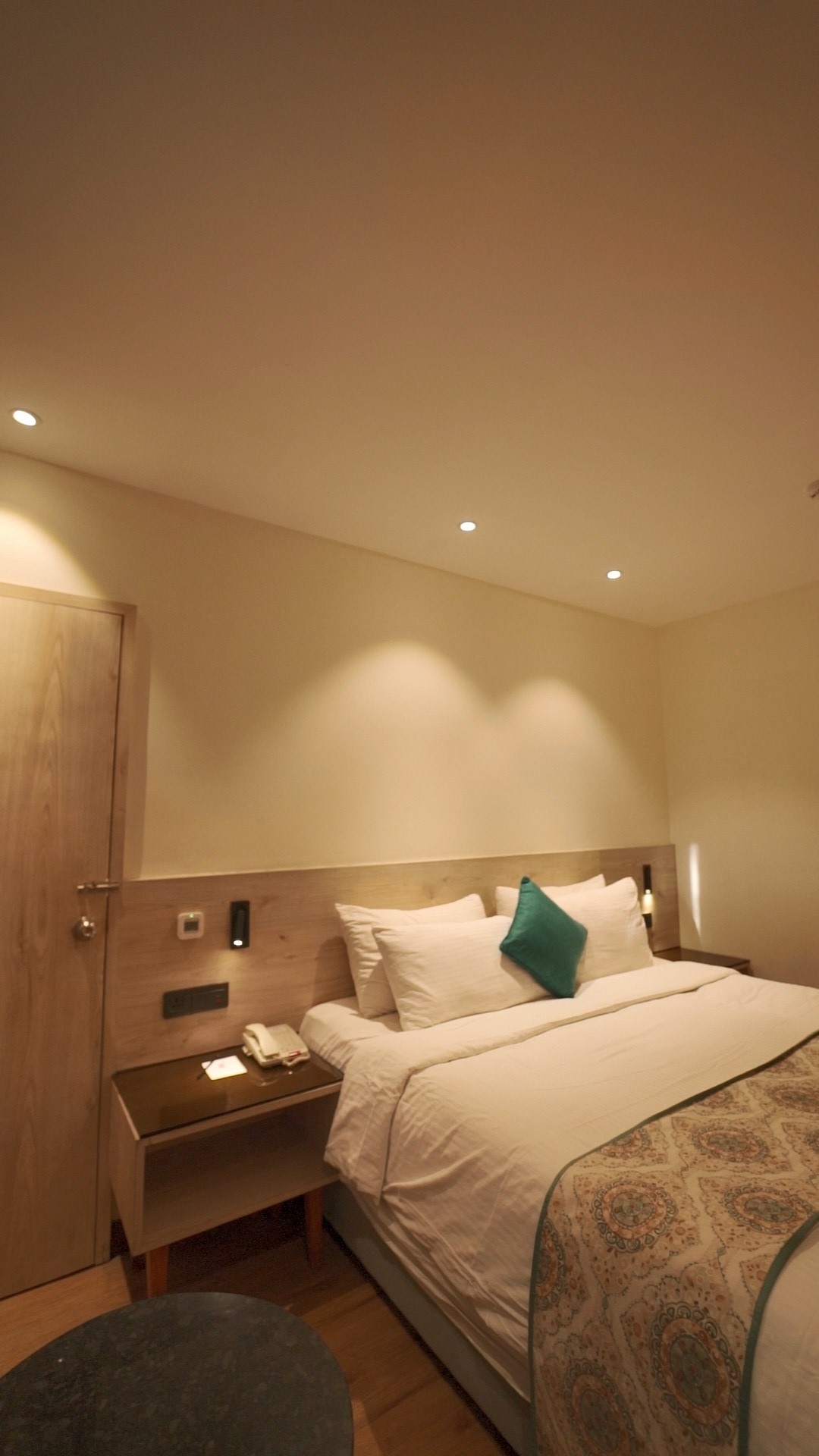 black and white bed near brown wooden table