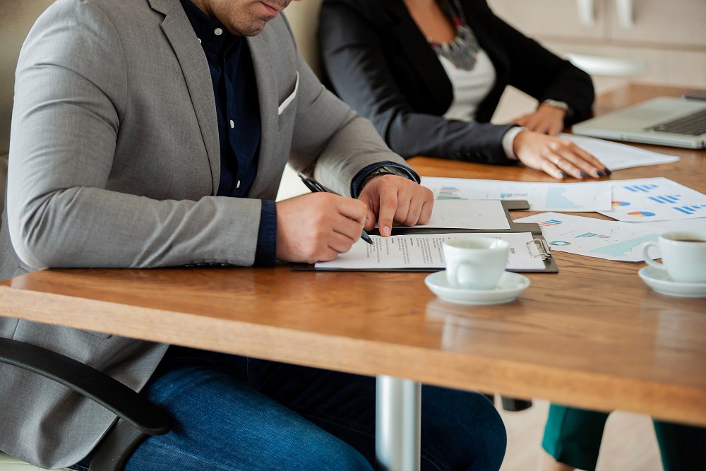 Businessmen preparing the necessary documentation for their RAKEZ company formation.