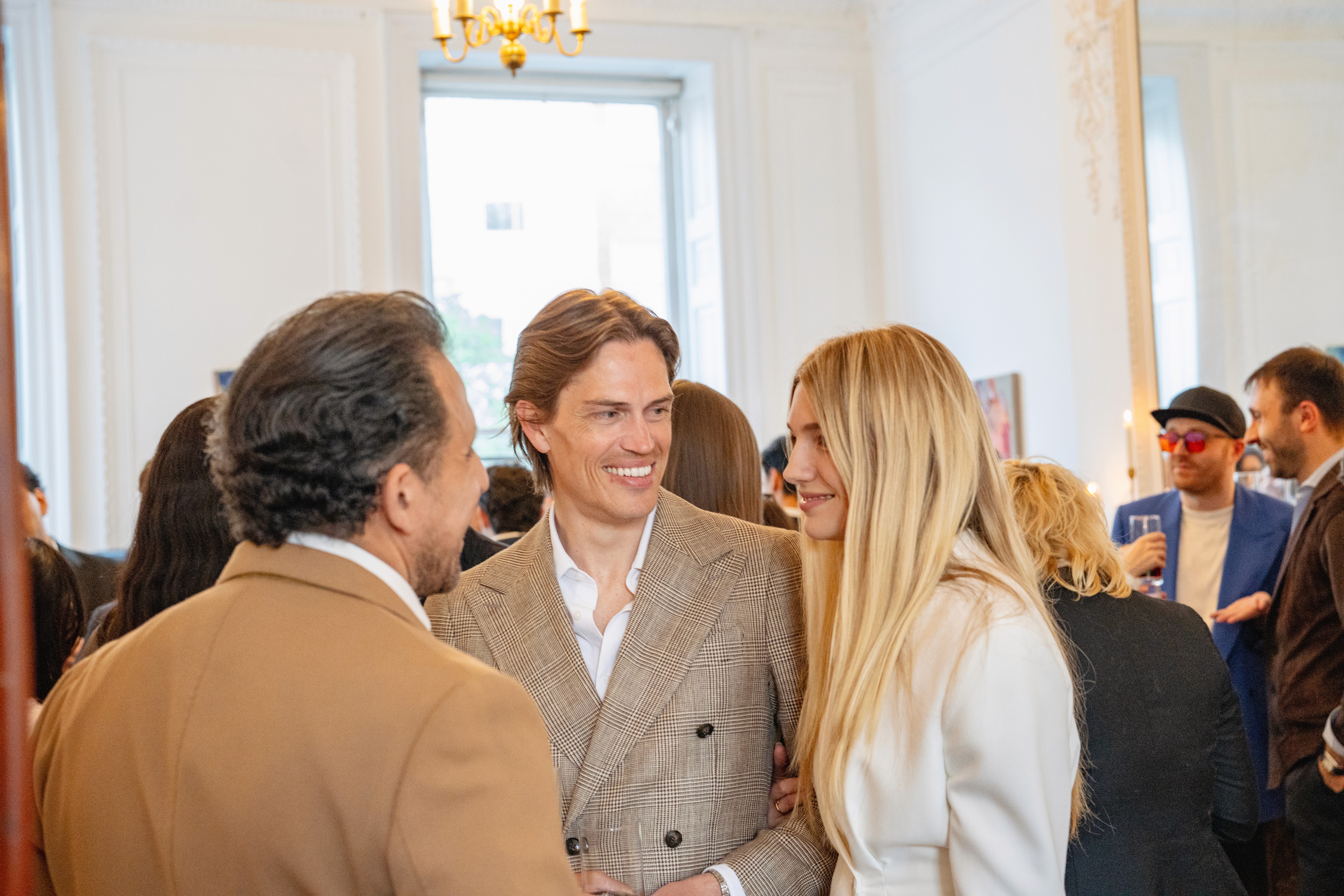 Members mingling and laughing together at a Meridian evening gathering